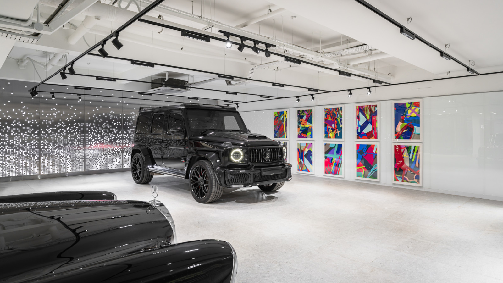 Motion-sensor activated lighting guides luxury vehicles into the basement garage, where up to 10 cars can be displayed