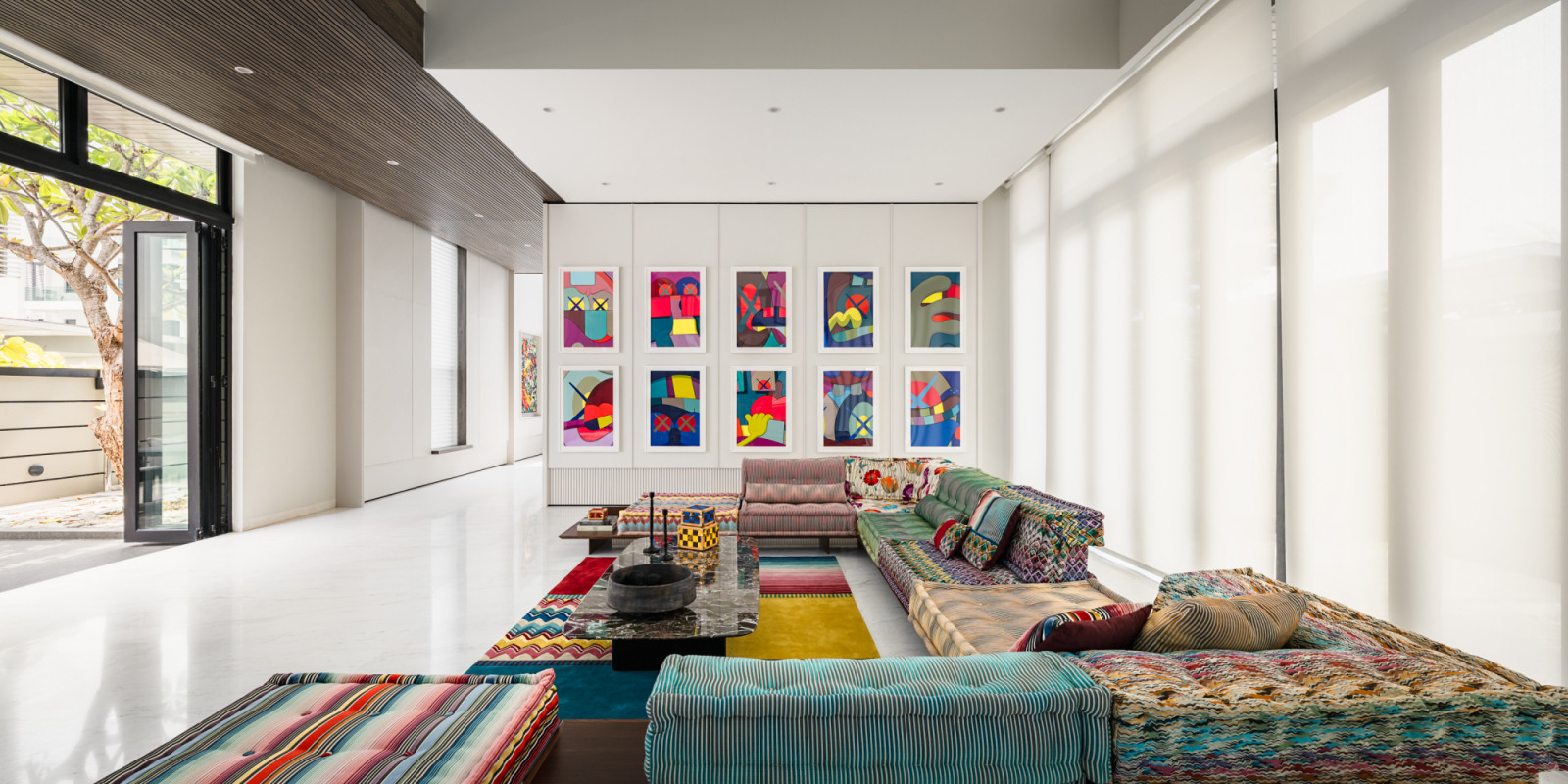 Soaring ceilings and abundant natural light characterise the main living area, where the ten-piece KAWS print collection creates a gallery-like atmosphere