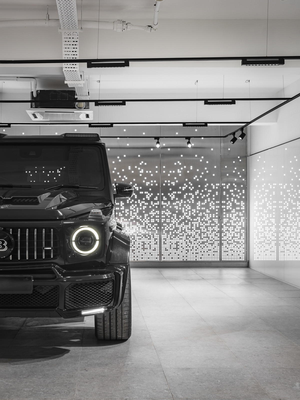 Motion-sensor activated lighting guides luxury vehicles into the basement garage, where up to 10 cars can be displayed