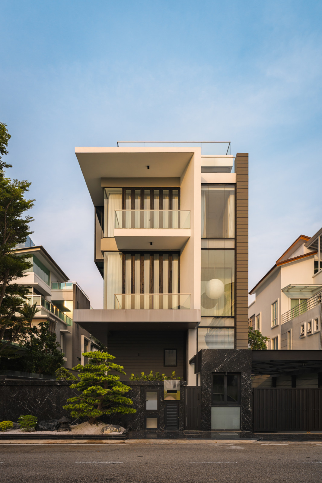 The four-storey residence in Seri Tanjung, Penang, displays clean modernist lines and expansive glazing
