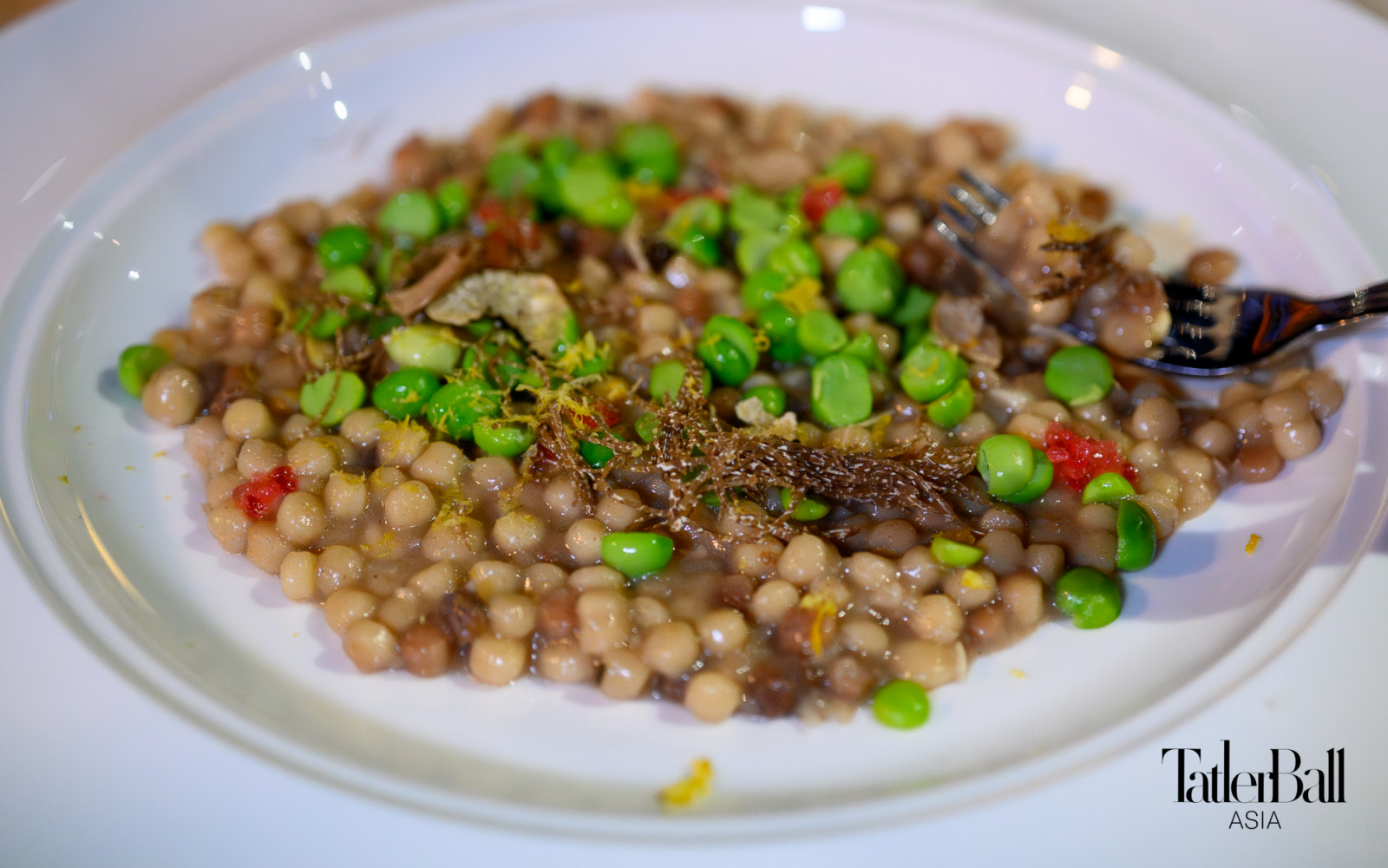 The fregola was served with sugar snap peas, finger lime with shavings of fresh black truffle