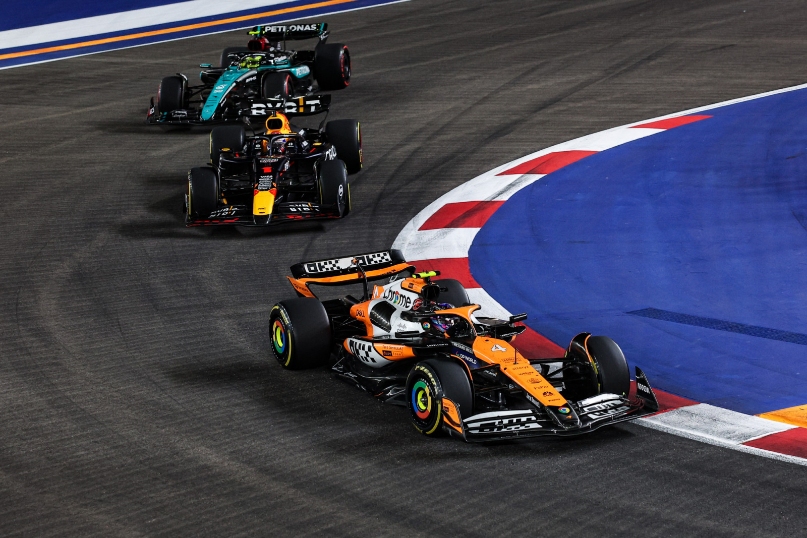 Lando Norris of McLaren F1 Team MCL38, Max Verstappen of Red Bull Racing RB20, and Lewis Hamilton of Mercedes AMG F1 Team W15 are in action during the Formula 1 Singapore Grand Prix 2024 on the Marina Bay Circuit, in Singapore, from September 19 to 22, 2024. (Photo by Gongora/NurPhoto via Getty Images)
