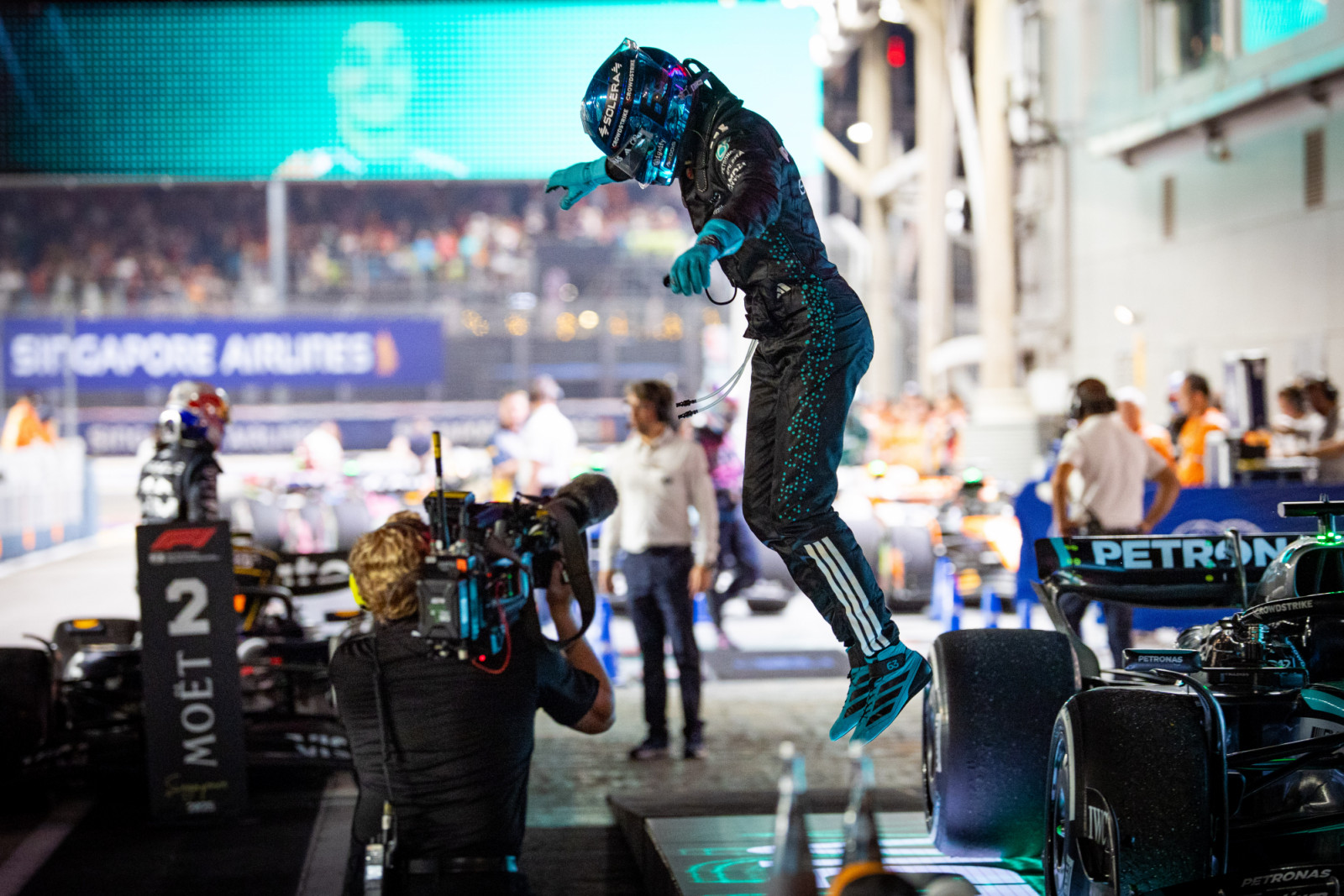 SINGAPORE, SINGAPORE - OCTOBER 5: George Russell of Great Britain and Mercedes jumps out of the car to celebrate victory in Parc ferme after the F1 Grand Prix of Singapore at Marina Bay Street Circuit on October 5, 2025 in Singapore, Singapore. (Photo by Kym Illman/Getty Images)