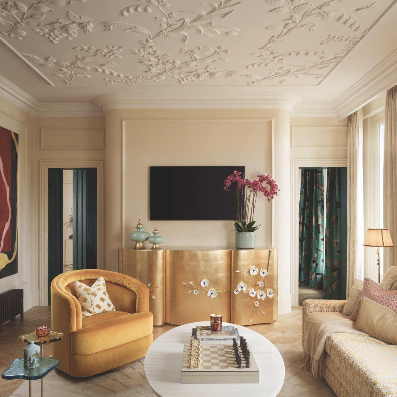 The drawing room features custom ceiling details with delicate butterfly motifs, a personal symbol cherished by the home’s American owners