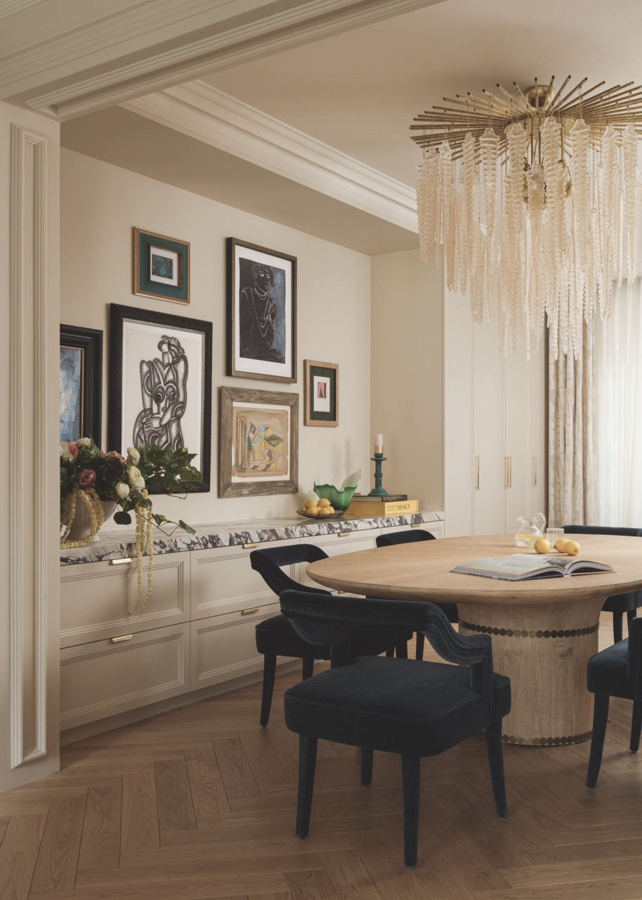 The dining room features a thoughtfully curated gallery wall of mid-century artworks sourced in collaboration with Lost Art Salon in San Francisco