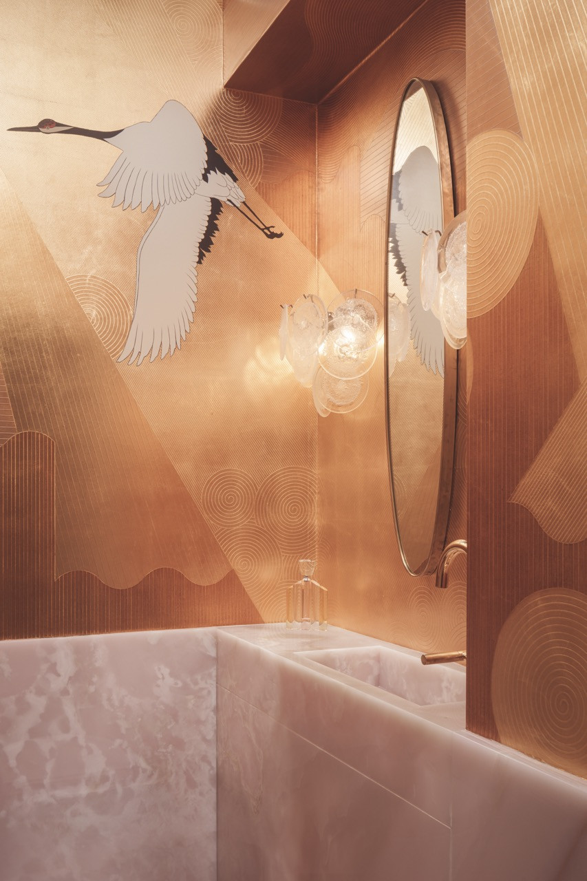 This compact powder room utilises striking pink onyx to communicate visual drama and luxury