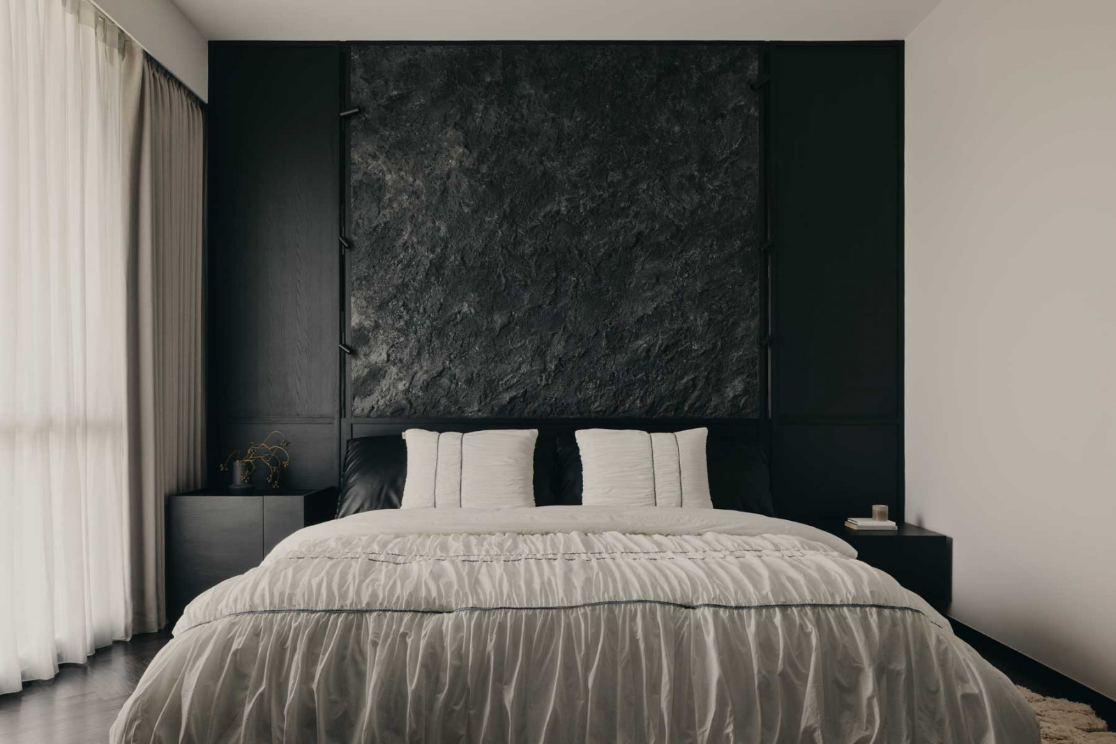 This textured wall takes centre stage in the bedroom in the House of Kin, in Gentle Darkness at Balmoral (Photo: Arche)
