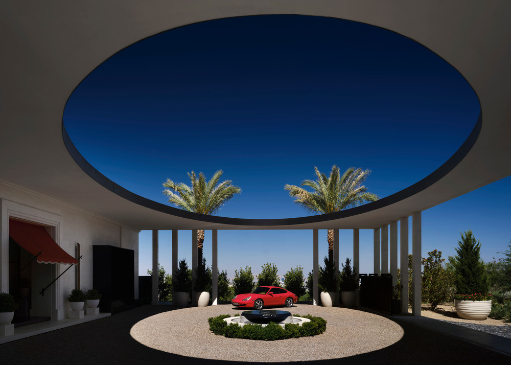 The circular auto court is centred on an oculus that frames the infinite desert sky