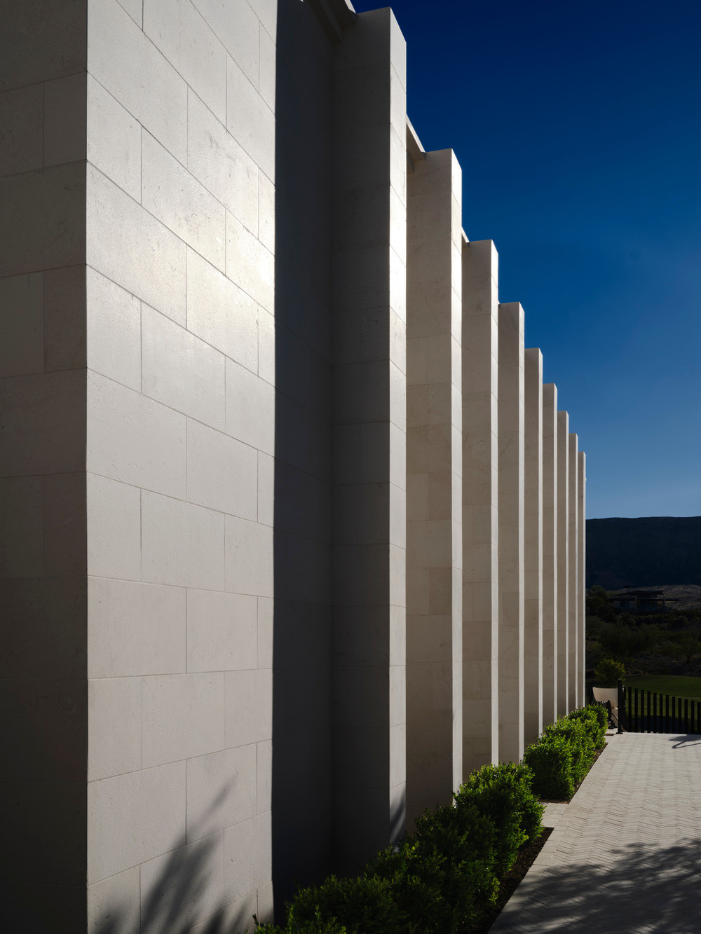 The stone façade casts dramatic shadows that shift with the passage of time