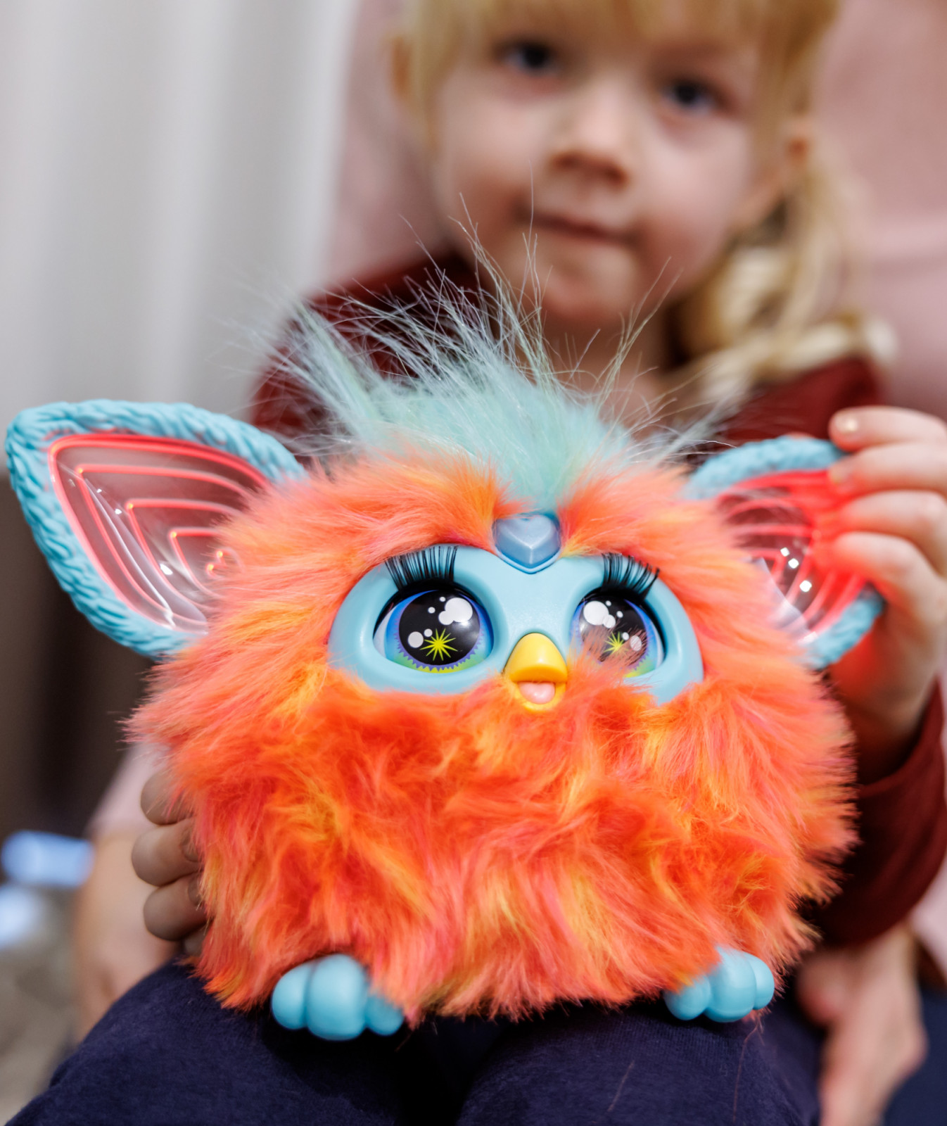 28 November 2023, Bavaria, Nuremberg: Five-year-old Franziska plays with the electronic furry animal Furby from Hasbro at the annual press conference of the German Toy Retail Association (BVS) and the German Toy Industry Association (DVSI). The toy is one of the "Top 10 Toys 2023" list published by the BVS. The DVSI and BVS provide an outlook on the important Christmas business and present figures for the past few months. Photo: Daniel Karmann/dpa (Photo by Daniel Karmann/picture alliance via Getty Images)
