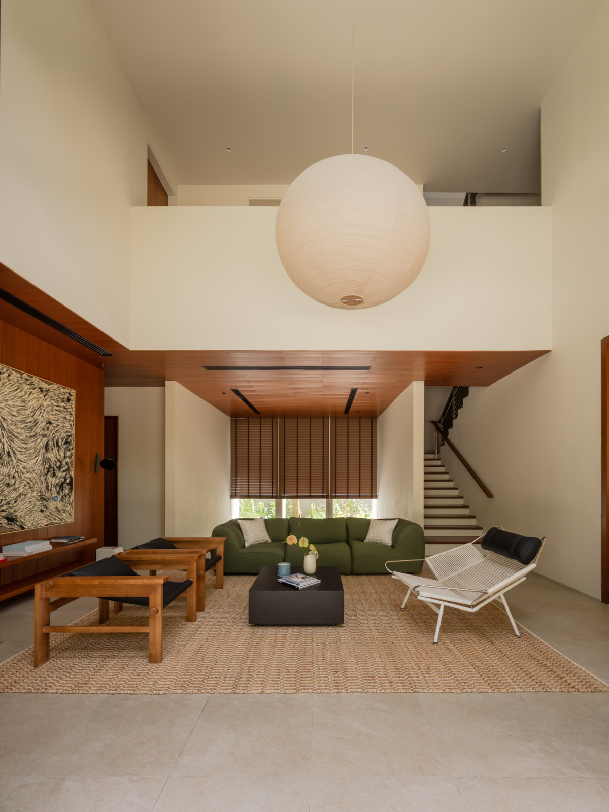The King Living’s 1977 sofa juxtaposes playfully with the minerality of the textured walls and the clean lines of the timber-clad ceiling