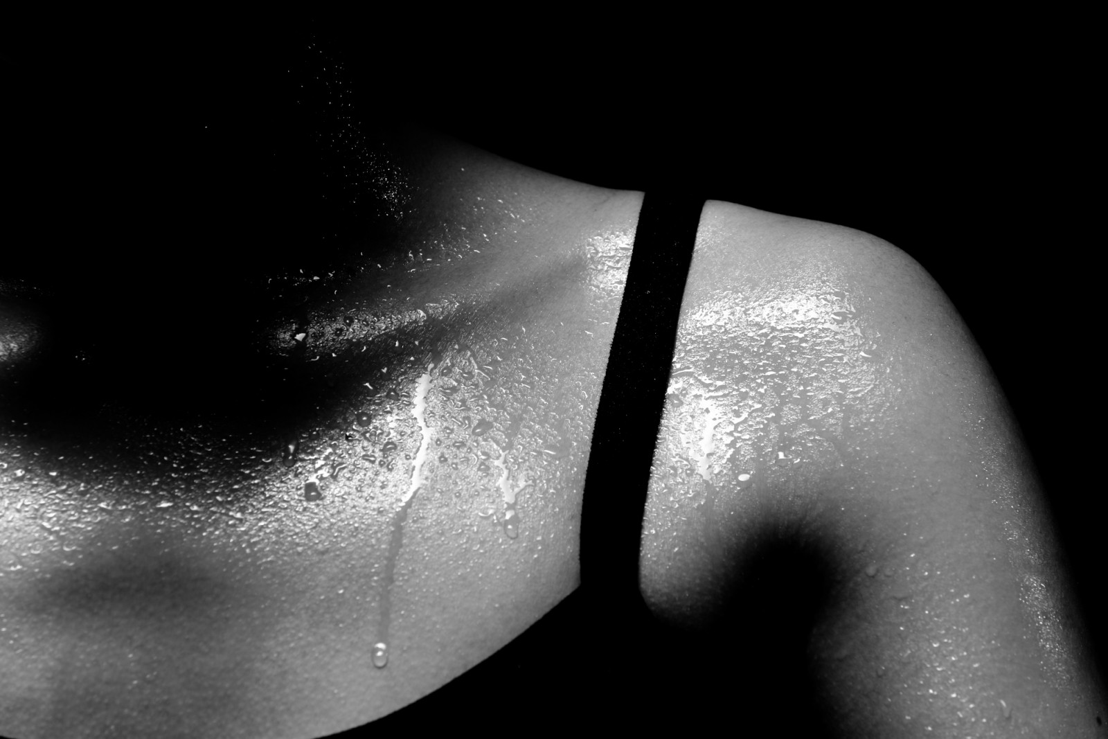 Asian Tan Skin Sport Girl in Fitness Bra long black pants, exercise sweat water drop in low key exposure lighting. black white concept no retouch, shoulder part