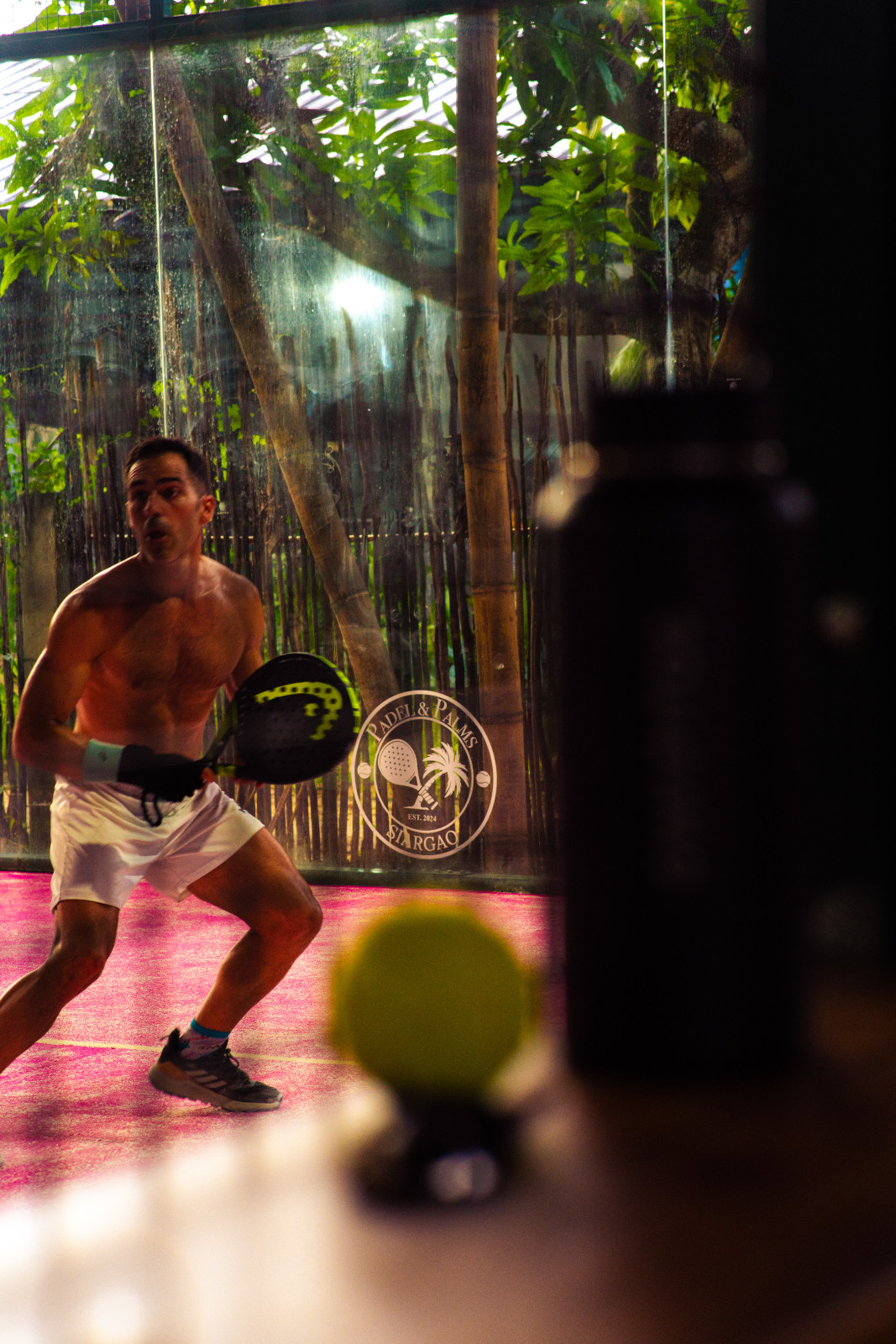 Members of the community playing padel on pink courts