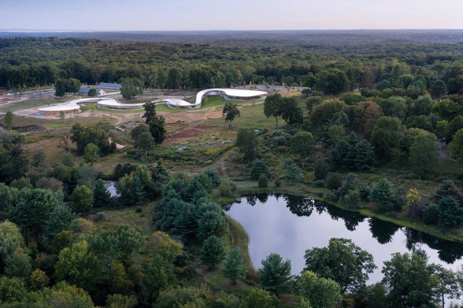 Grace Farms in Connecticut, a 32ha cultural centre, features the sinuous River building set amid renovated barns (Photo: Iwan Baan)