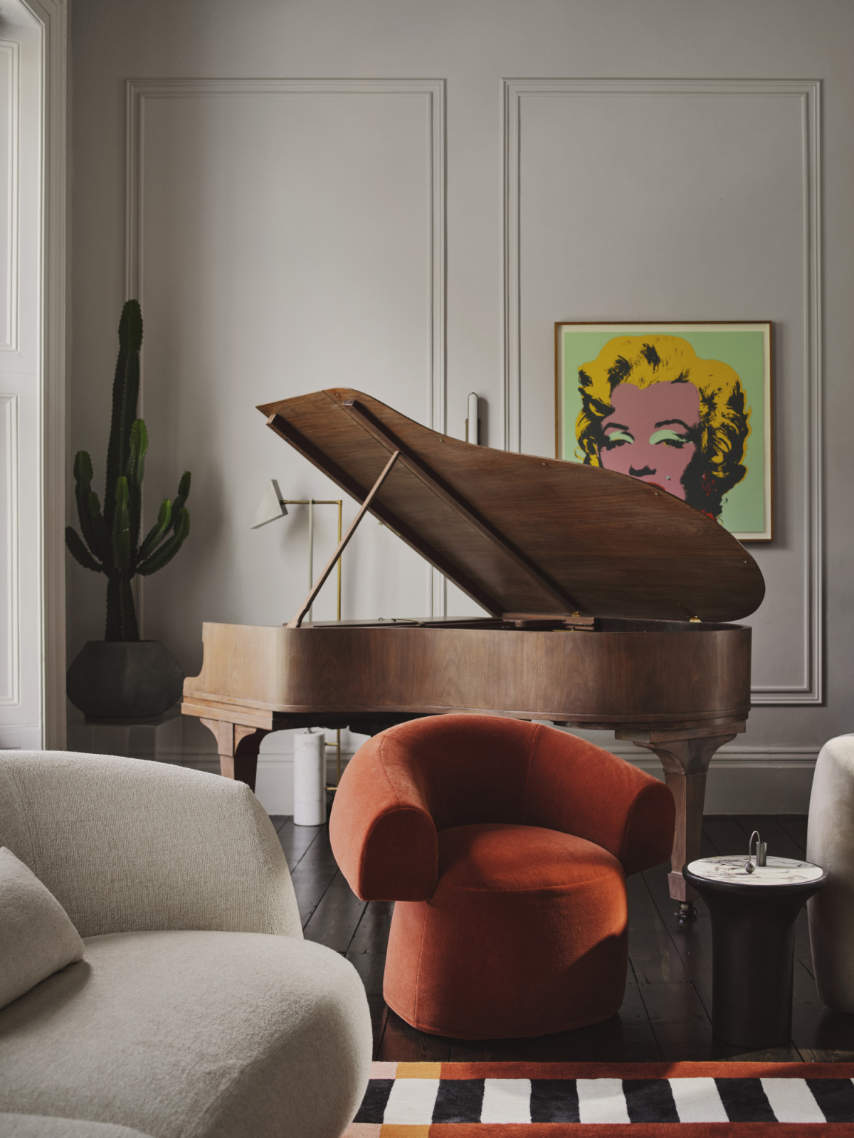 The living room of a Dublin, Ireland home by Maison RA-D, which features an antique Steinway Boudoir grand piano