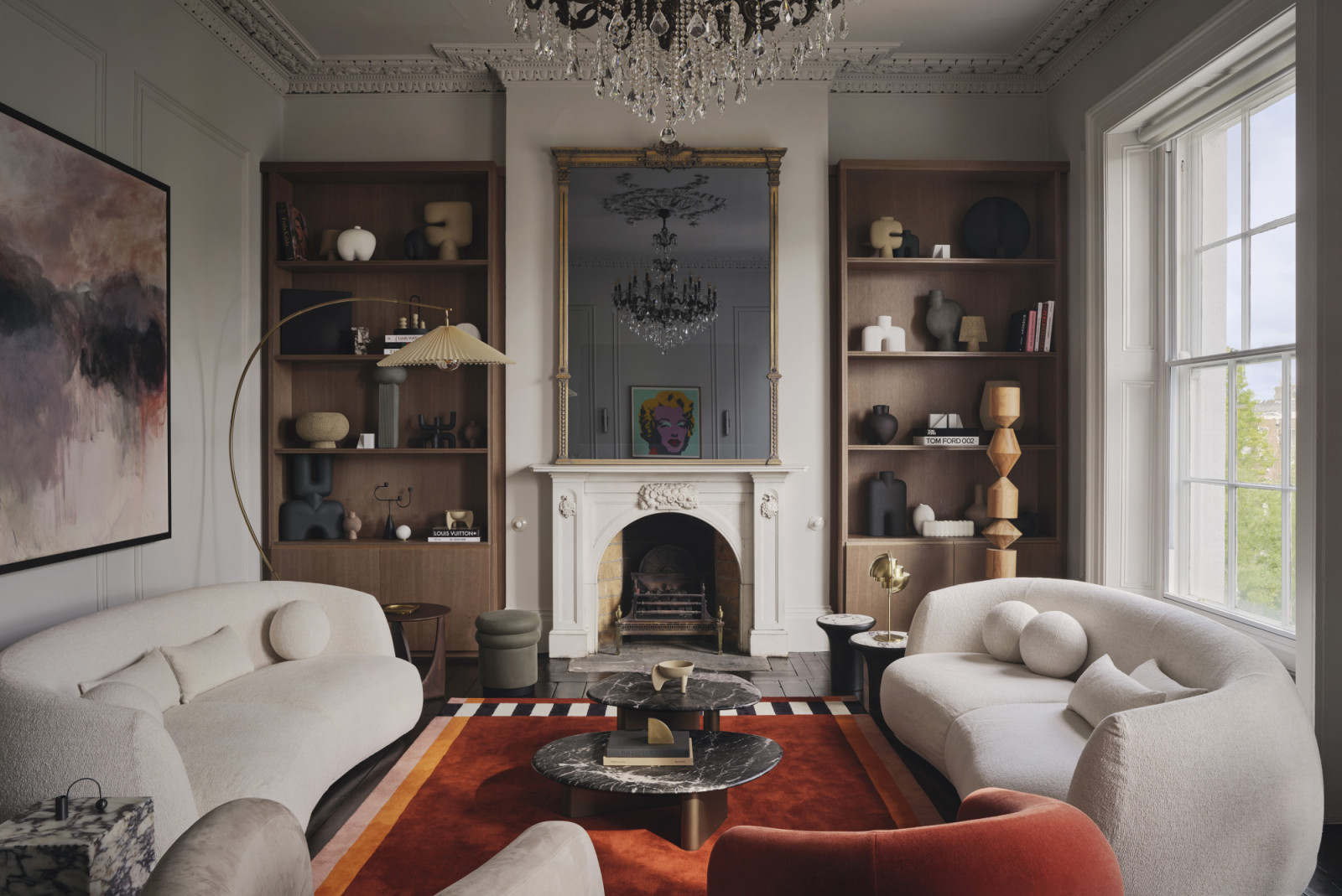 The living room of a Dublin, Ireland home by Maison RA-D, with Strict Rayures Rug by CC Tapis, Pacific Sofa by Patricia Urquiola for Moroso, Plinth side table by Audo CPH, Pouf by Studio Pepe for Gallloti Radice, Arc Floor Lamp by Soho Home, Callisto Coffee tables by Porada, Constantina Floor Lamp by Einrichten Design, Bull Floor Lamp by Square in Circle, Lagoa lounge chair by Tachinni, Ruff Armchair by Moroso, Geometric side table by Ethnicraft, bespoke joinery by DFL, and display objets by 101 CPH