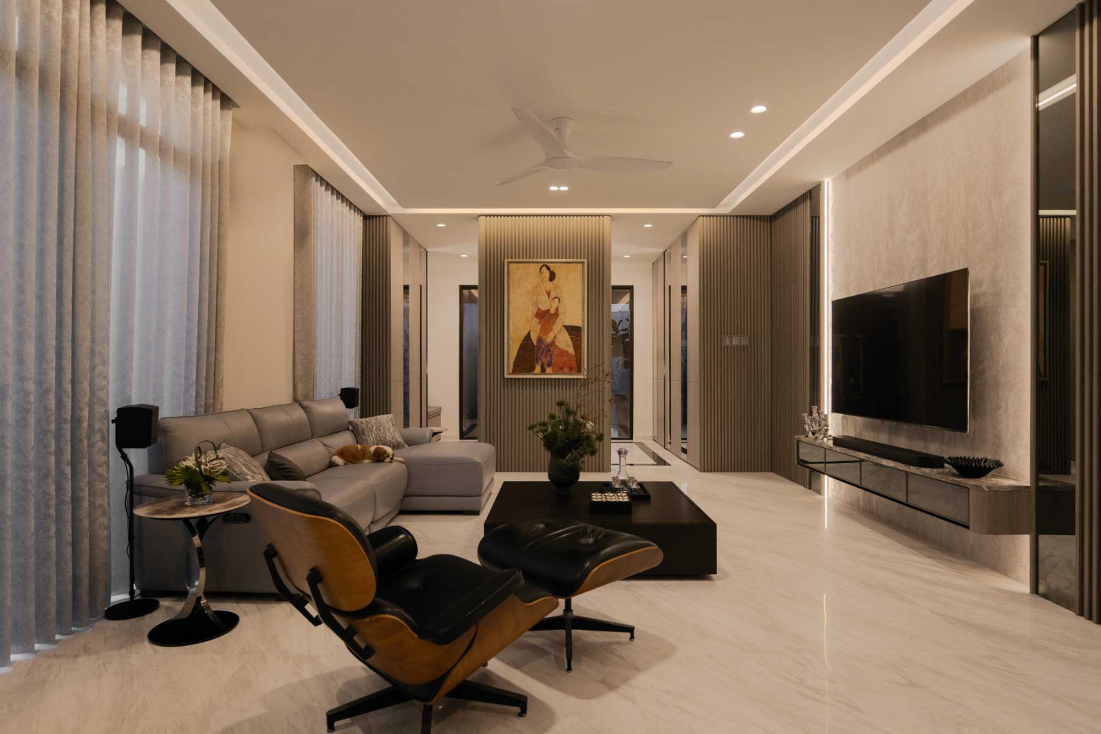The living room is defined by a fluted wall finish and a Herman Miller Eames lounge chair and ottoman (Photo: Mr Shopper Studio)