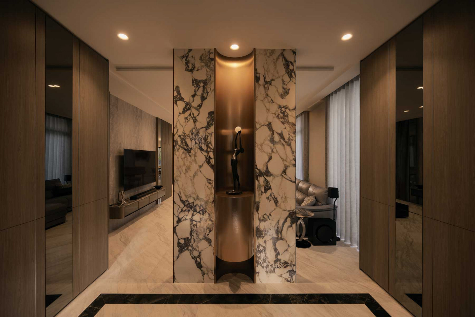 The reverse side of the feature wall is articulated in marble with a niche that houses a sculpture (Photo: Mr Shopper Studio)