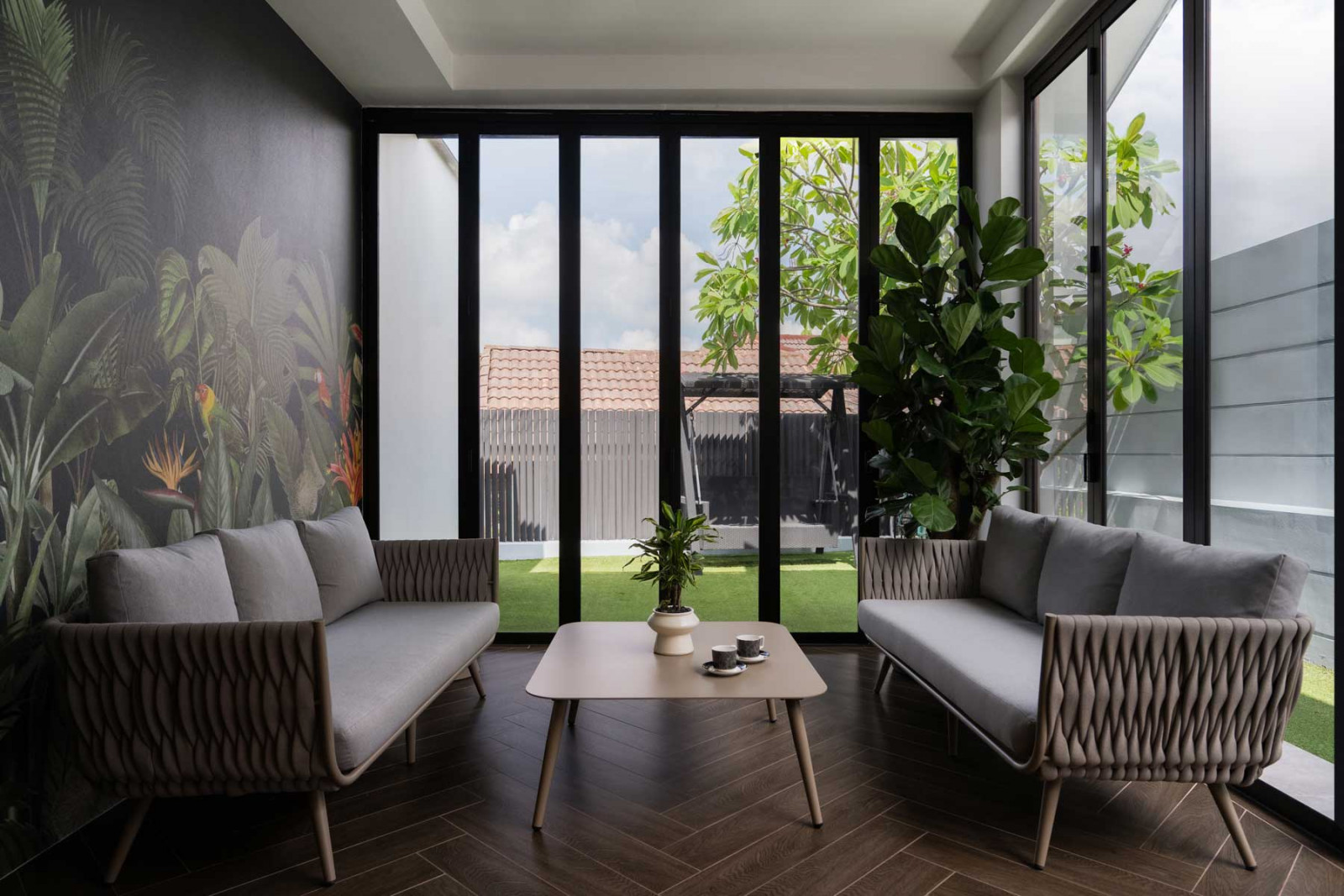 Tropical-jungle wallpaper and lush greenery place this indoor garden lounge in lockstep with the outdoors (Photo: Mr Shopper Studio)