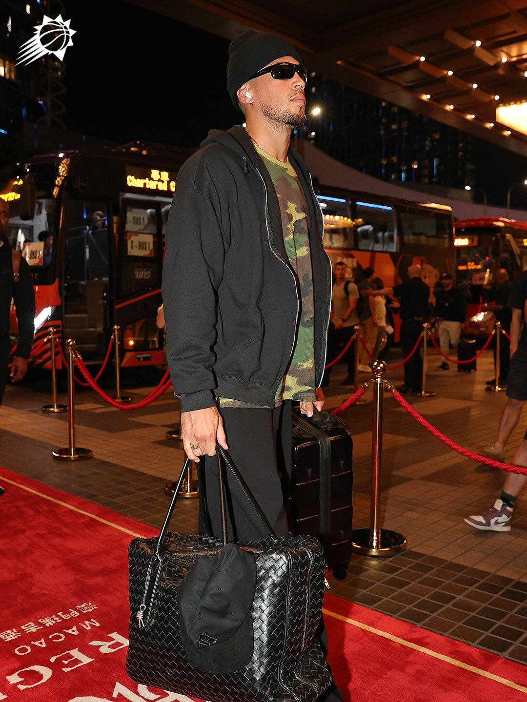 Devin Booker carries a Bottega Veneta Intreciatto leather briefcase. (Photo: Suns / Instagram)