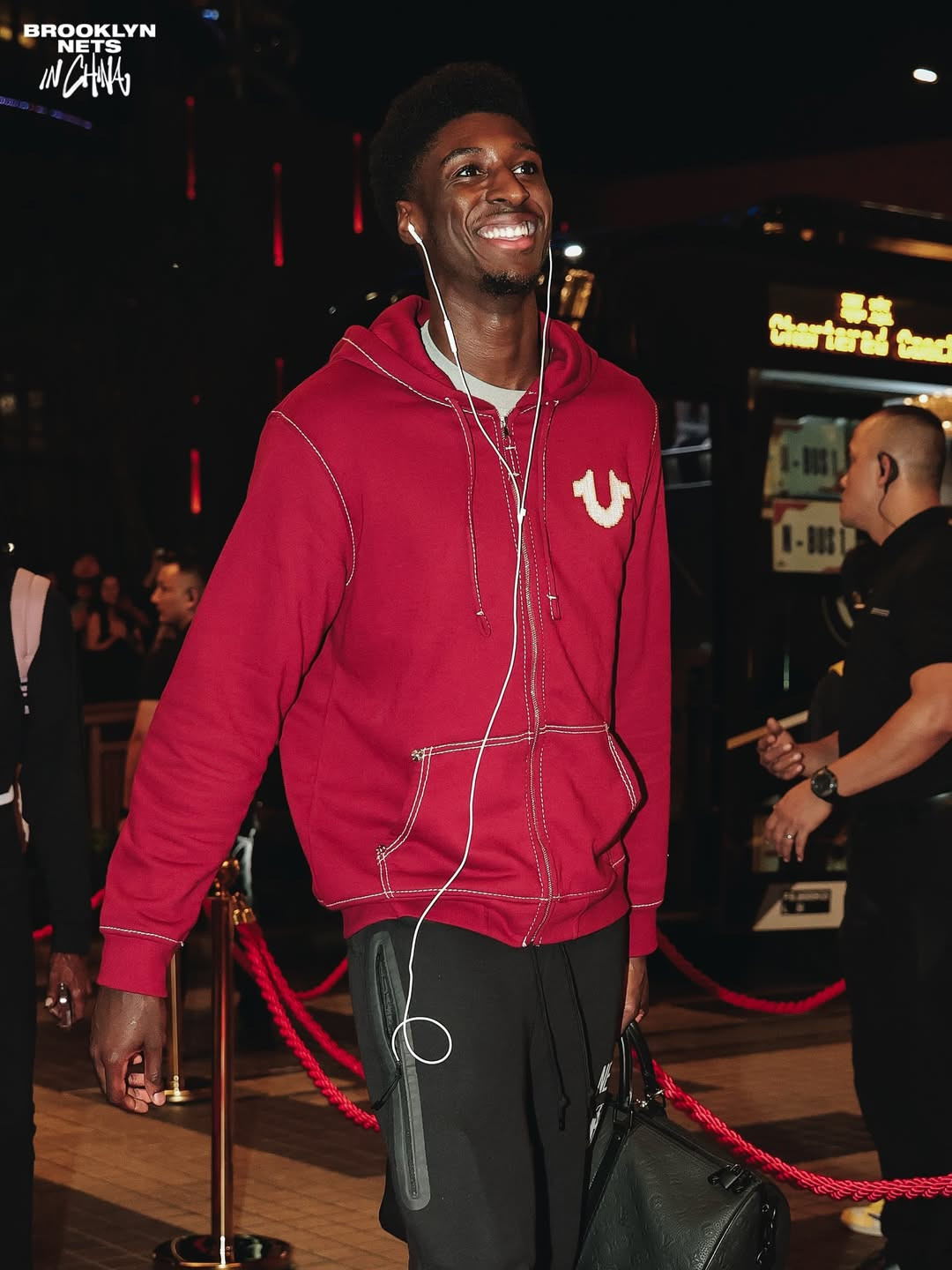 Drake Powell wears a True Religion hoodie and carries a Louis Vuitton duffel.  (Photo: Brooklyn Nets / Instagram)