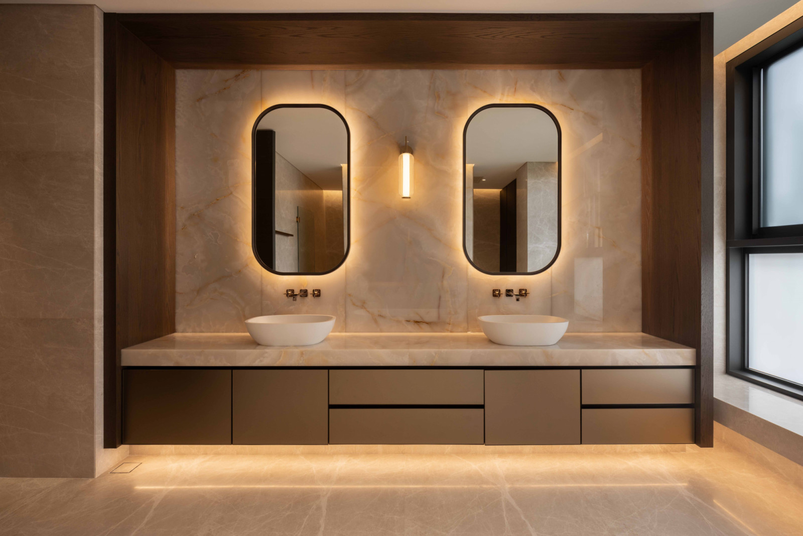A well-lit double vanity with subtle curves sets the stage for a serene morning routine