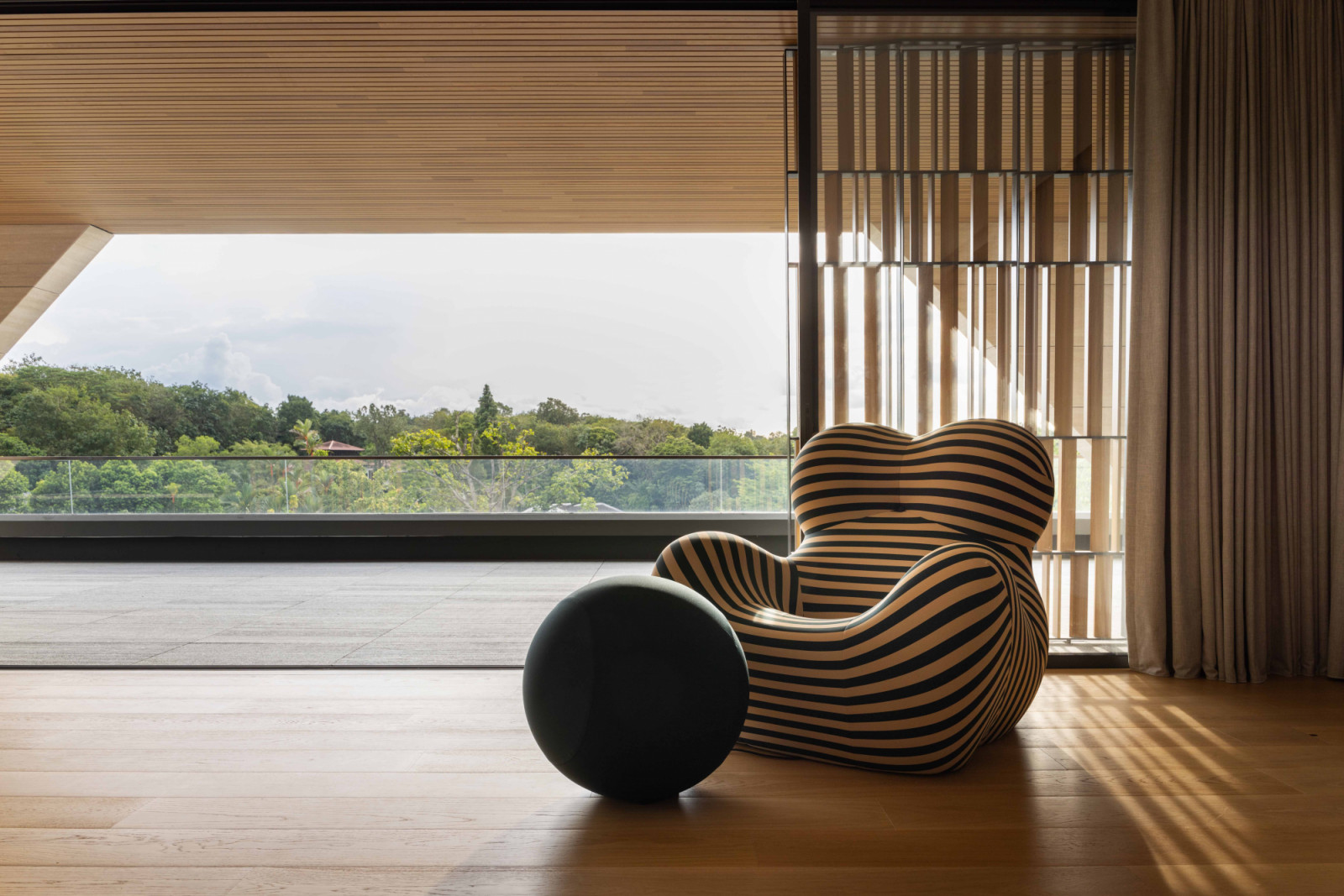 The iconic B&B Italia UP5 and 6 sofa and ottoman stand in the foreground of the stunning view from this balcony