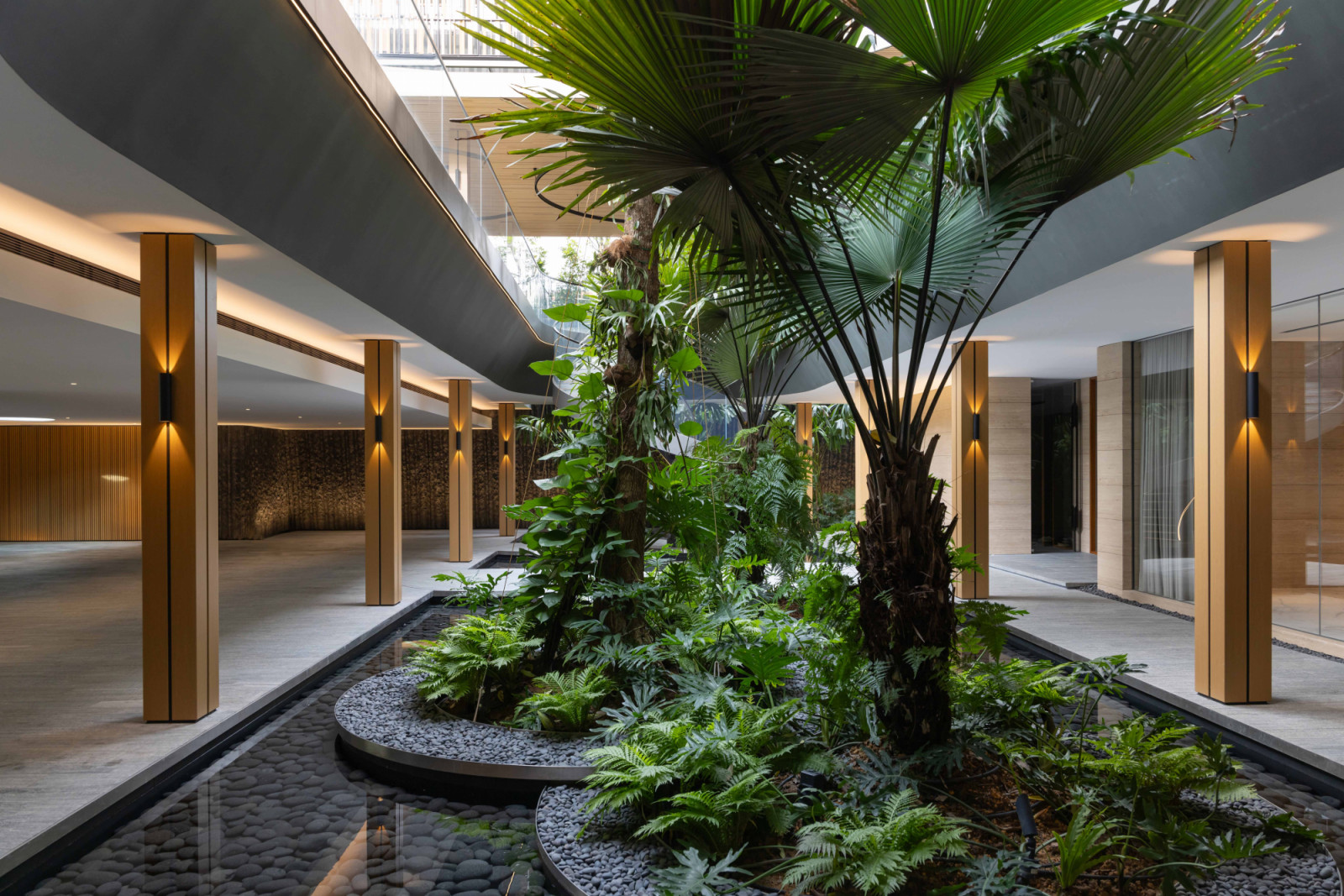 A pocket of lush garden and a water feature by Salad Dressing enliven the basement carpark