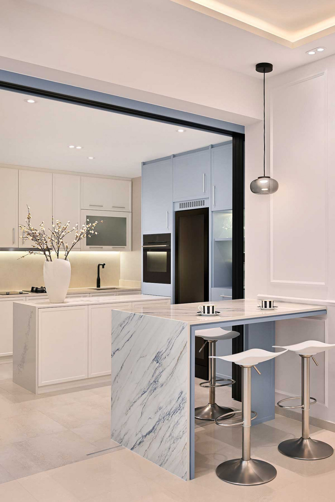 A sleek breakfast counter and kitchen in one of the studio’s projects which conceals much more storage than meets the eye