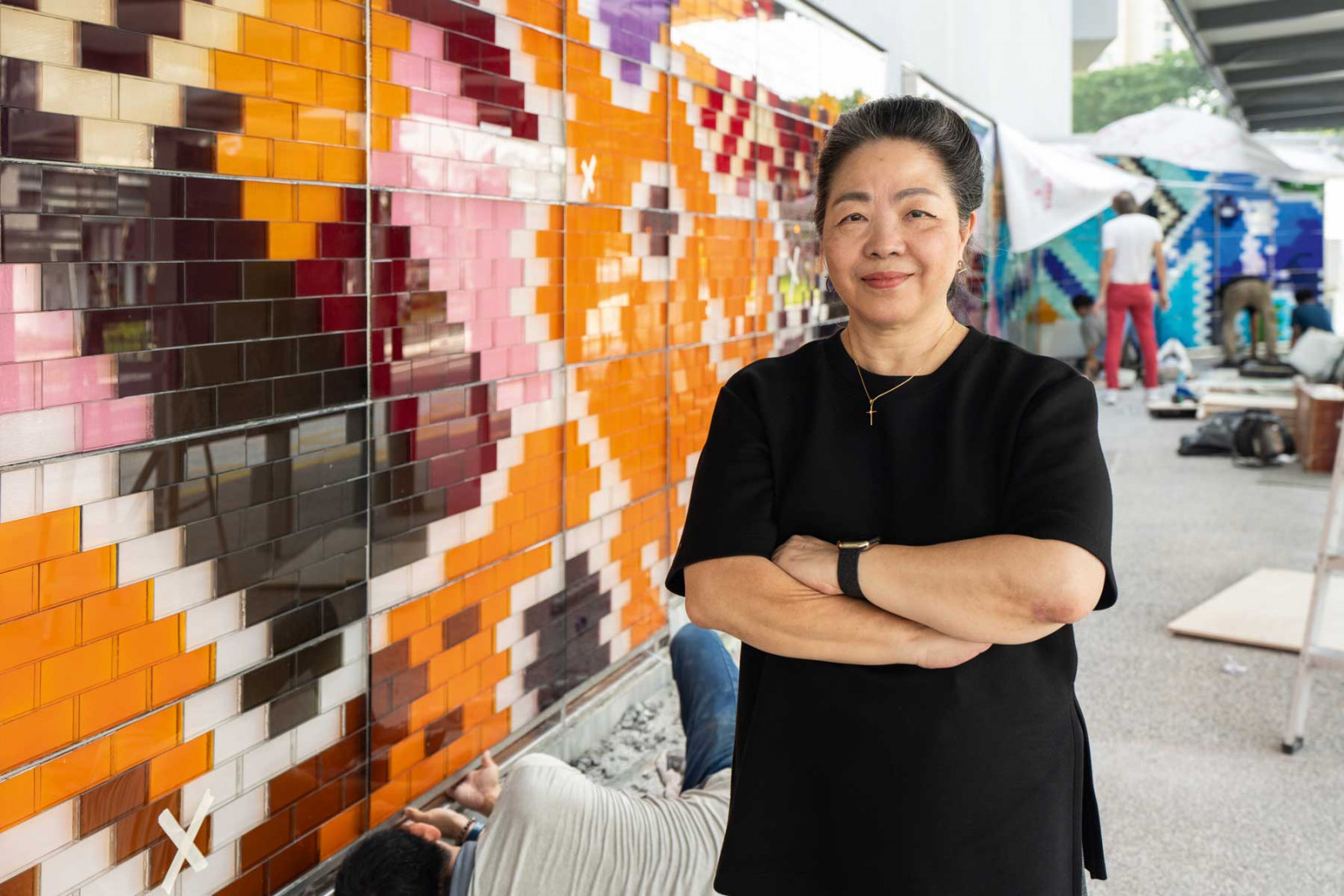 Synergraphic founder Florence Ng in front of Nostalgia, a glass-brick artwork at Holland Village inspired by old playgrounds