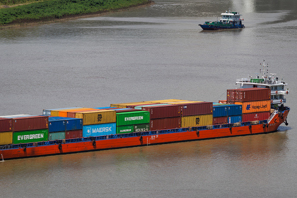 CHONGQING, CHINA - AUGUST 17: A container ship loaded with shipping containers from Evergreen, Maersk, Hapag-Lloyd, and other logistics companies sails along the Yangtze River on August 17, 2025 in Chongqing, China. Chongqing, as a key inland port city and transportation hub, plays a crucial role in China's Belt and Road Initiative and international trade. (Photo by Cheng Xin/Getty Images)