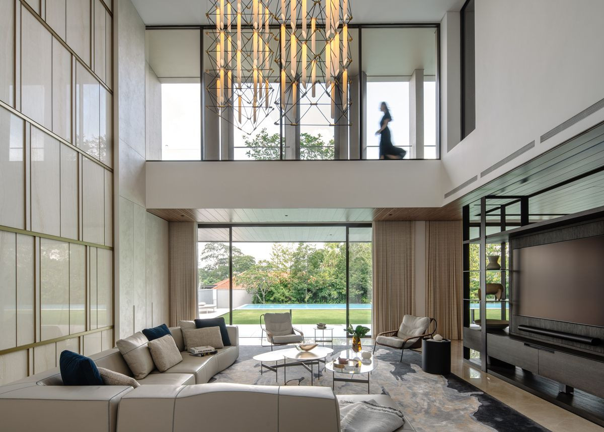 The Good Class Bungalow’s double-volume formal living room offers a view of the pool