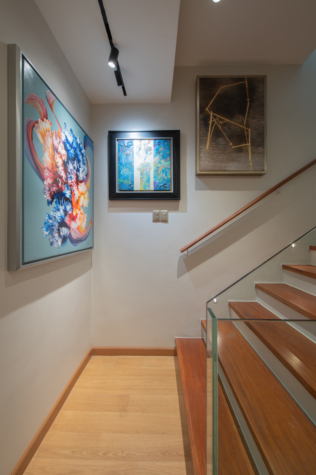 The upstairs hallway of a Makati home designed by architect Freddy Bautista, alongside interior designers Loubs and Ricia Gardiola, featuring an expansive collection by Filipino artists
