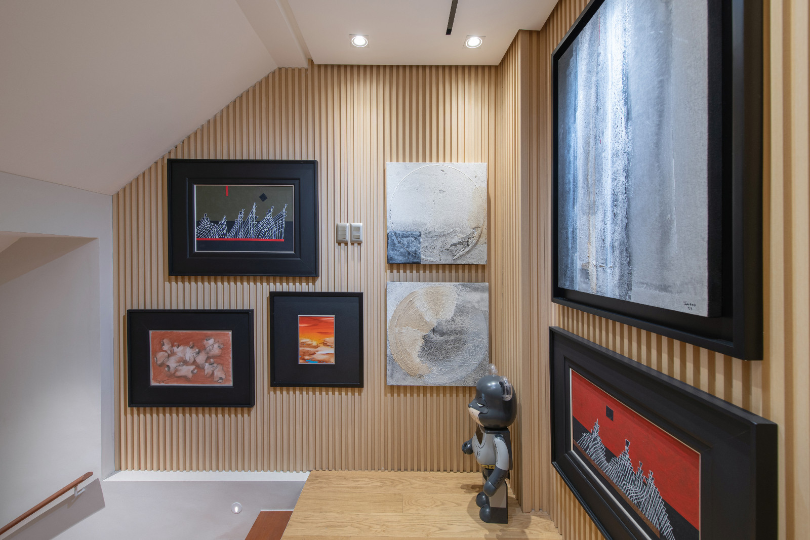 The upstairs hallway of a Makati home designed by architect Freddy Bautista, alongside interior designers Loubs and Ricia Gardiola, featuring an expansive collection by Filipino artists