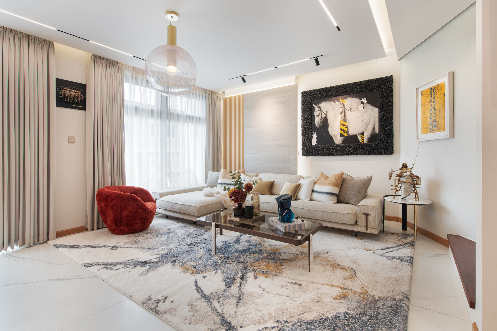The living room of a Makati home designed by architect Freddy Bautista, alongside interior designers Loubs and Ricia Gardiola, featuring an expansive collection by Filipino artists