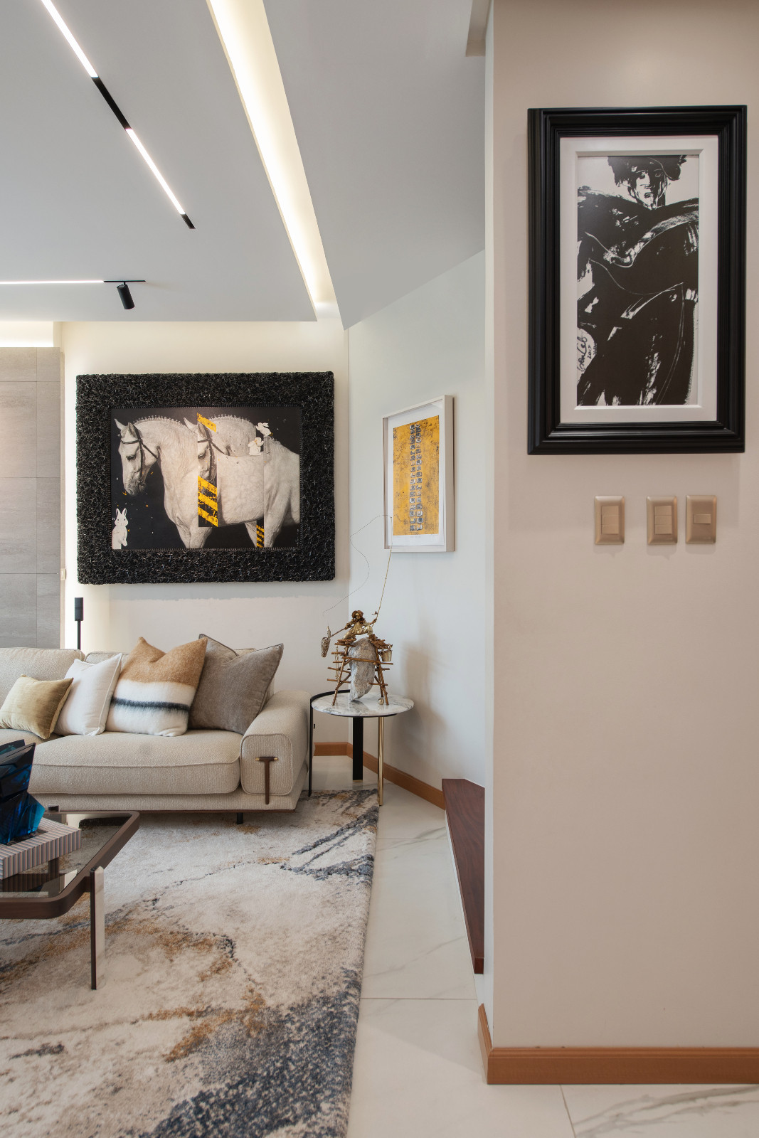 The living room of a Makati home designed by architect Freddy Bautista, alongside interior designers Loubs and Ricia Gardiola, featuring an expansive collection by Filipino artists