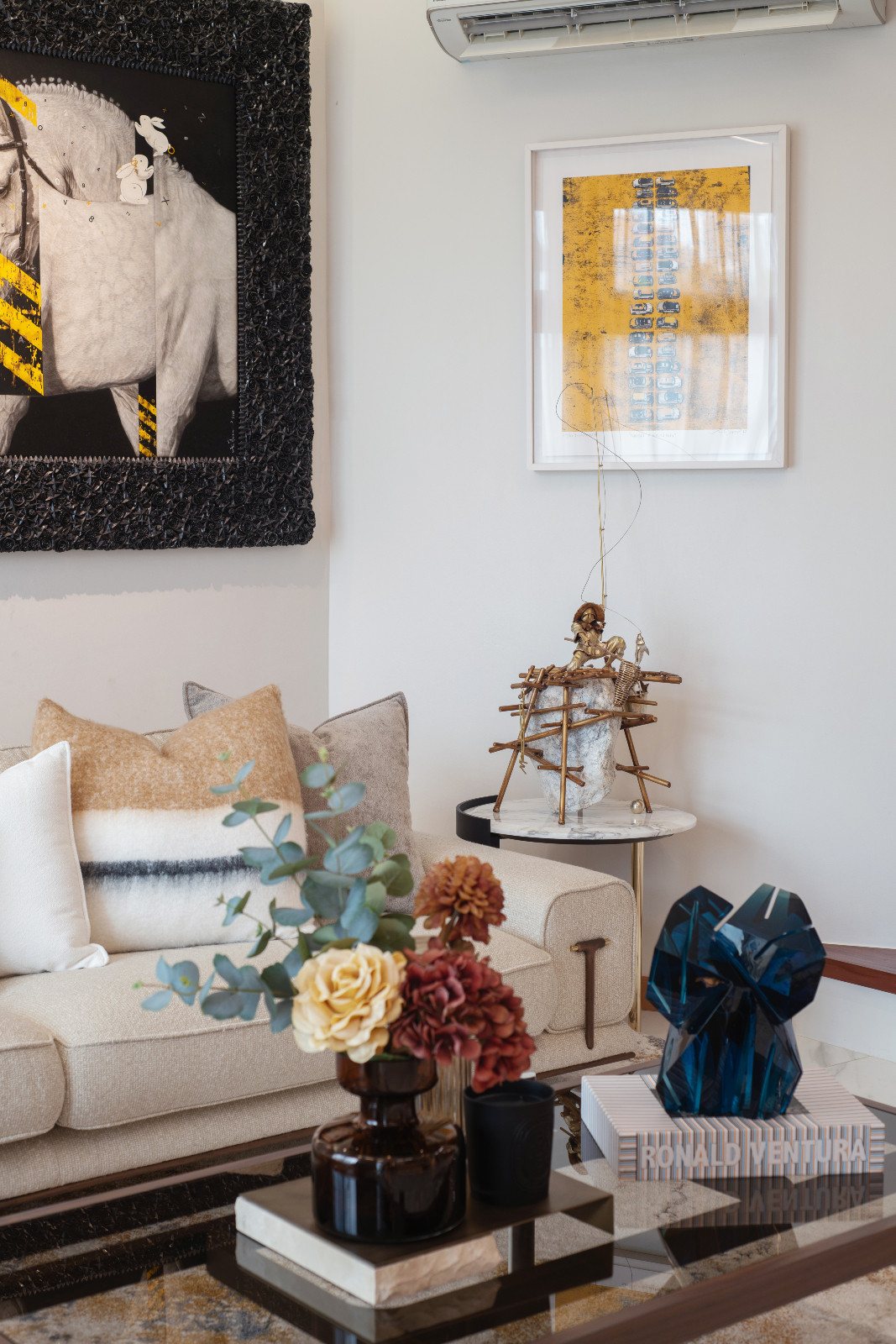 The living room of a Makati home designed by architect Freddy Bautista, alongside interior designers Loubs and Ricia Gardiola, featuring an expansive collection by Filipino artists