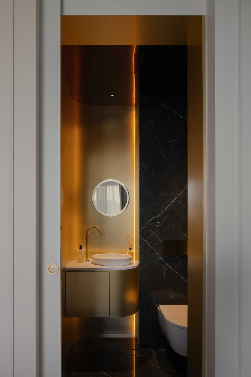 The powder room shimmers with metallic accents