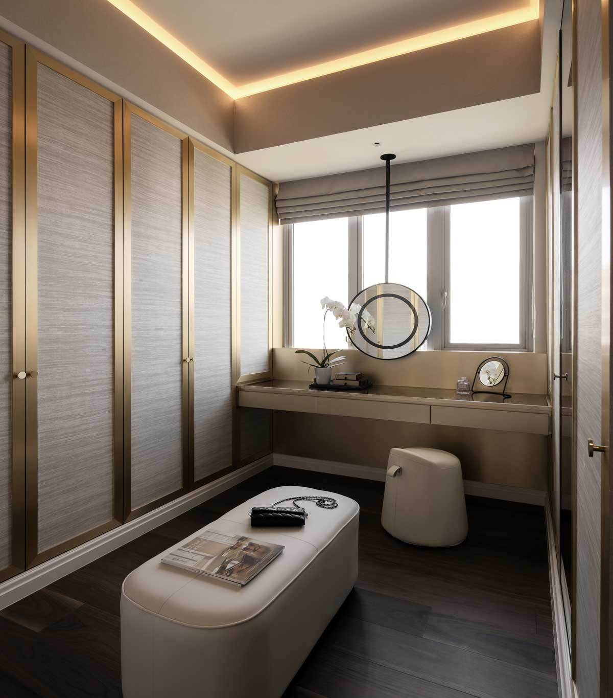 The dressing area is defined by graceful curves and brass detailing