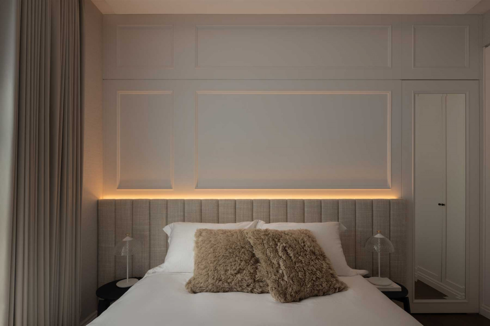 The bedroom layers fine textures and neutral tones to create a tactile retreat