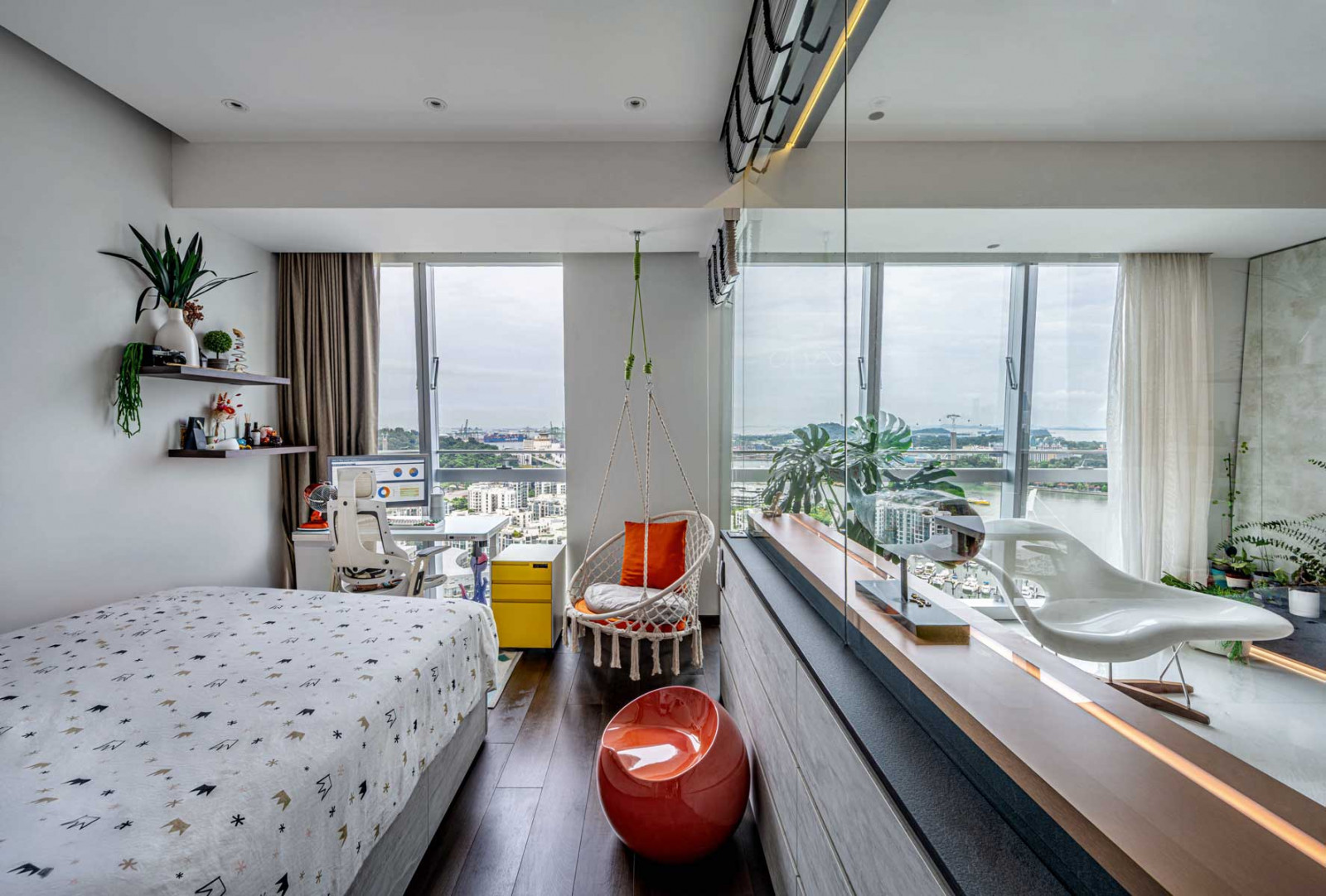 A scattering of accent pieces and soft furnishings in bright tones brings a tempered dose of liveliness to this restful bedroom with a view