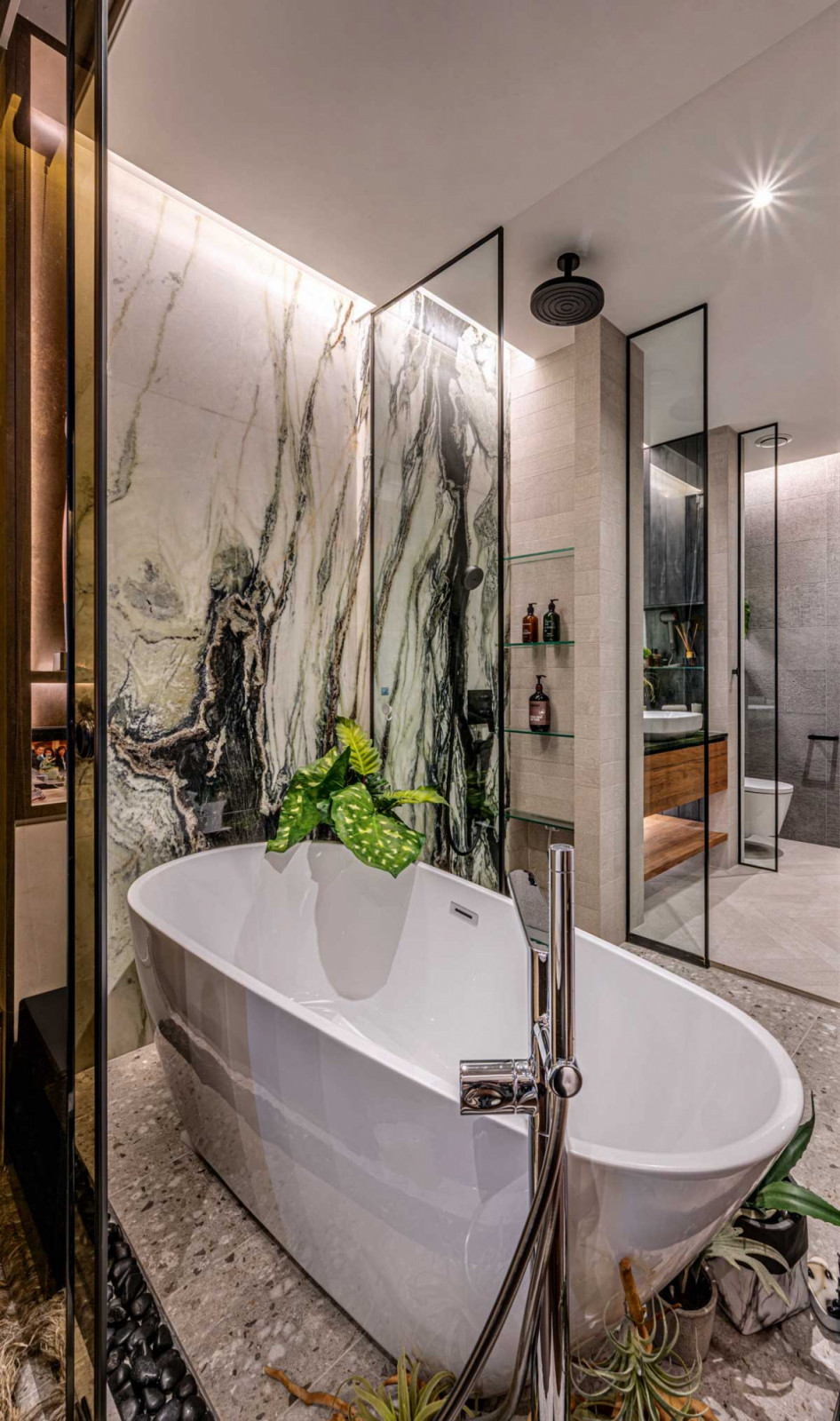 Book-matched marble slabs bring a dramatic yet tranquil air to the bathroom