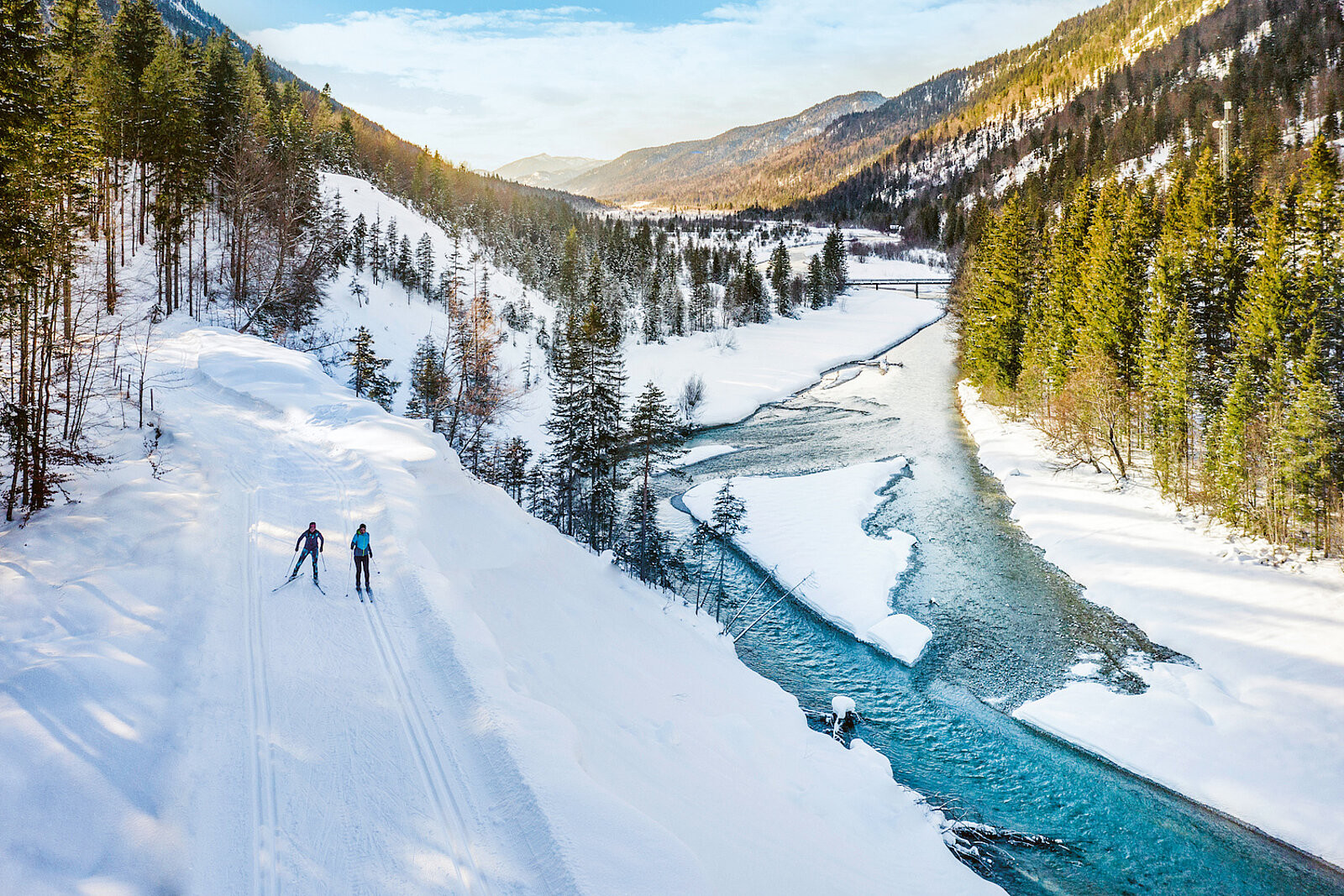 Descend pristine snow-covered slopes with dramatic Alpine peaks framing the horizon (Photo: HunterMoss)