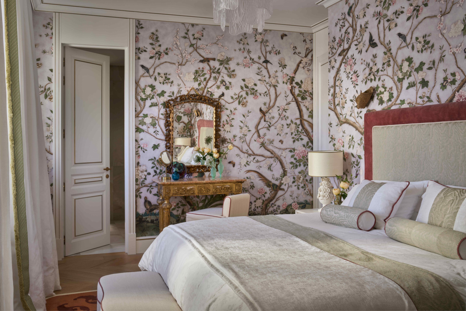 Schumacher wallpaper dresses one of the bedrooms in a rosy blush pink