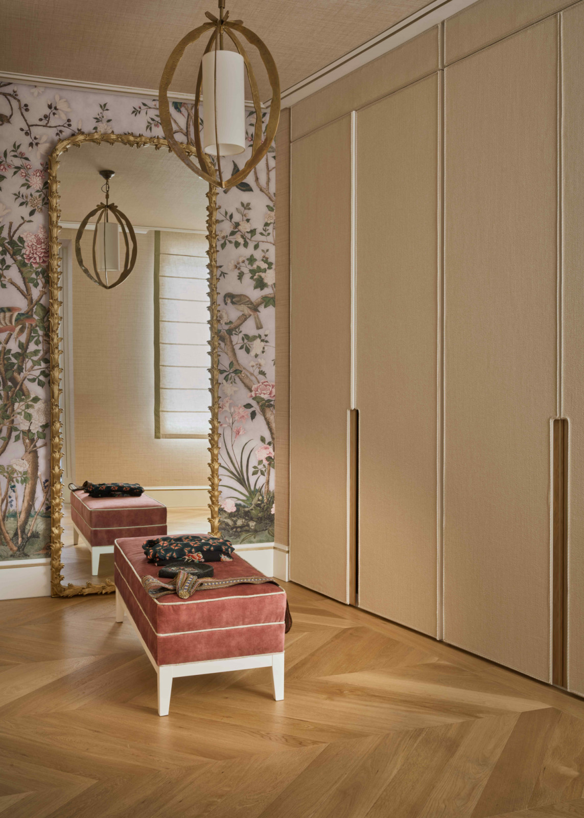 The adjacent wardrobe room with an Eichholtz chandelier and custom-made wardrobe with Gaston y Daniela fabric