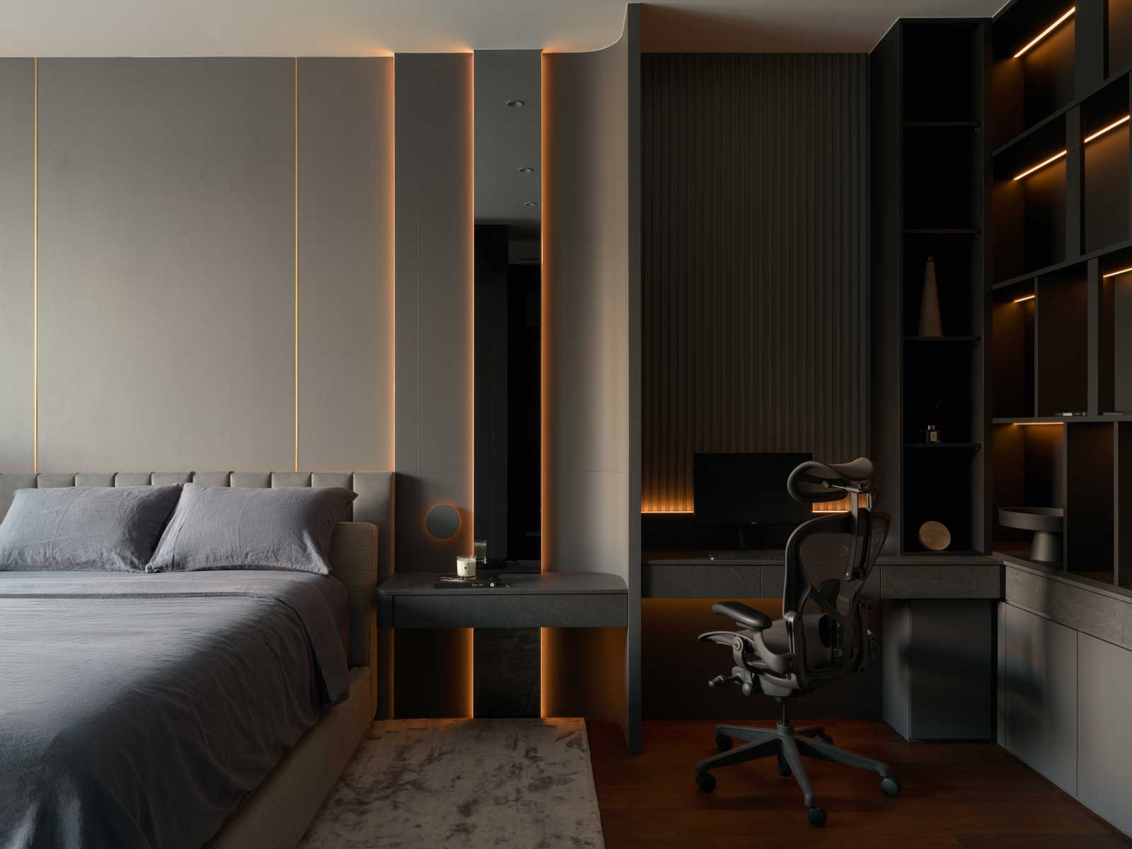 The dark, handsome palette of the master bedroom and study is enhanced by subtle lighting