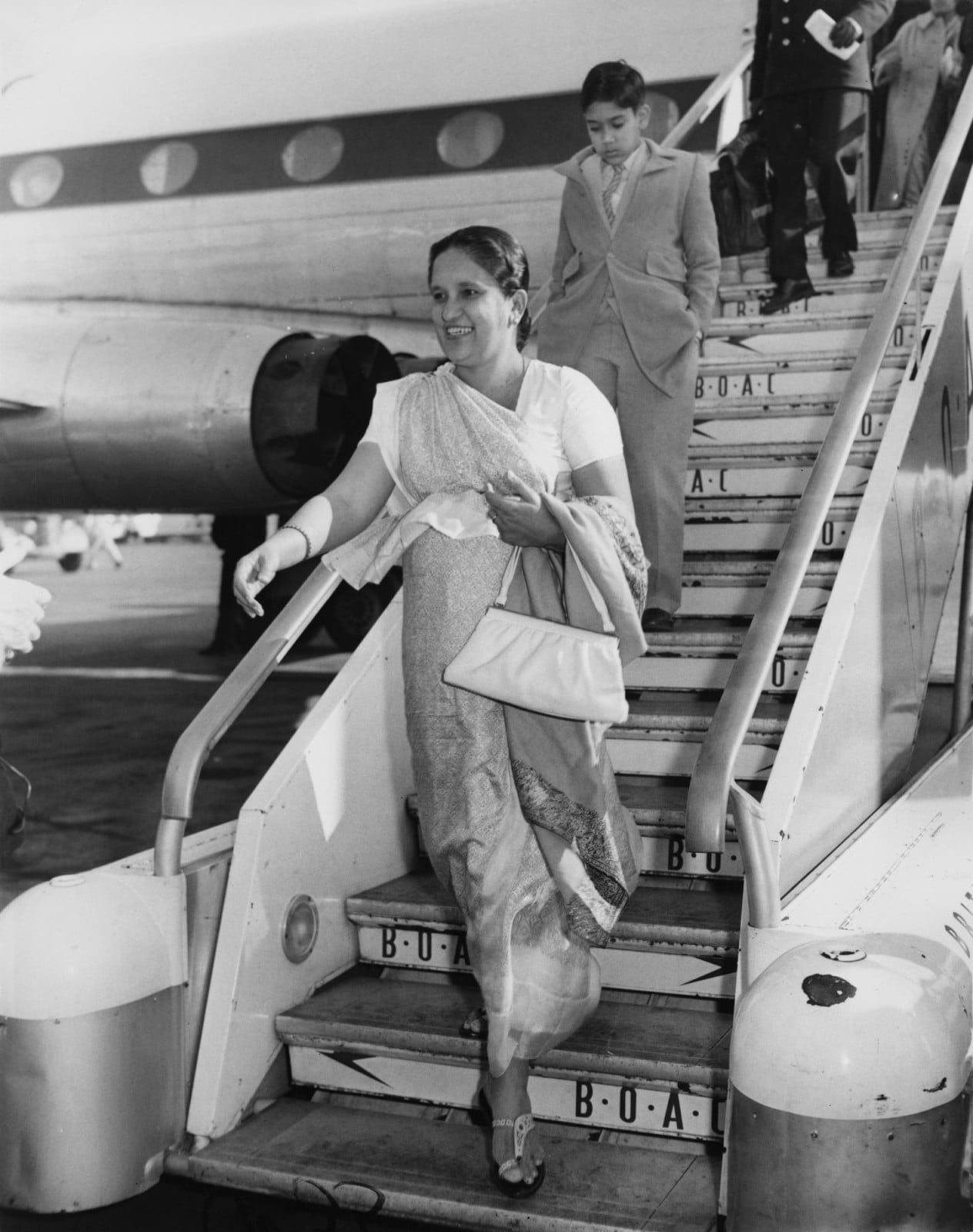 Sirimavo Bandaranaike (1916 - 2000), the Prime Minister of Ceylon (later Sri Lanka), arrives at London Airport with her son Anura, to attend the Commonwealth Prime Ministers' Conference in London, 5th March 1961. She is the world's first female head of state. (Photo by J. Wilds/Keystone/Hulton Archive/Getty Images)
