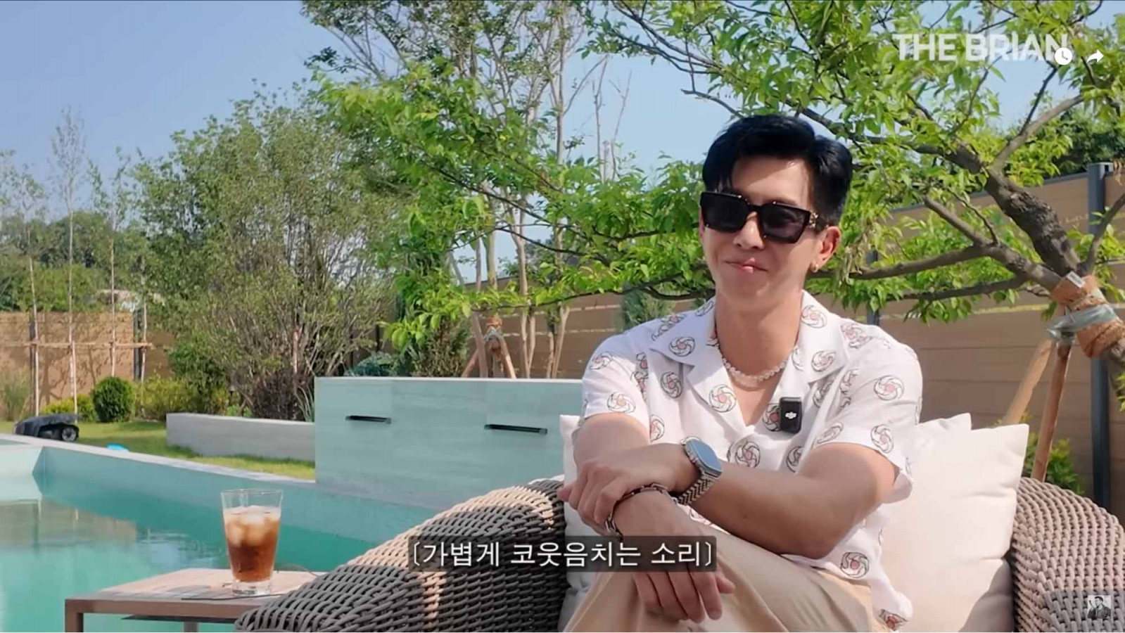 Brian Joo sitting by his outdoor pool (Photo: Youtube / The Brian)