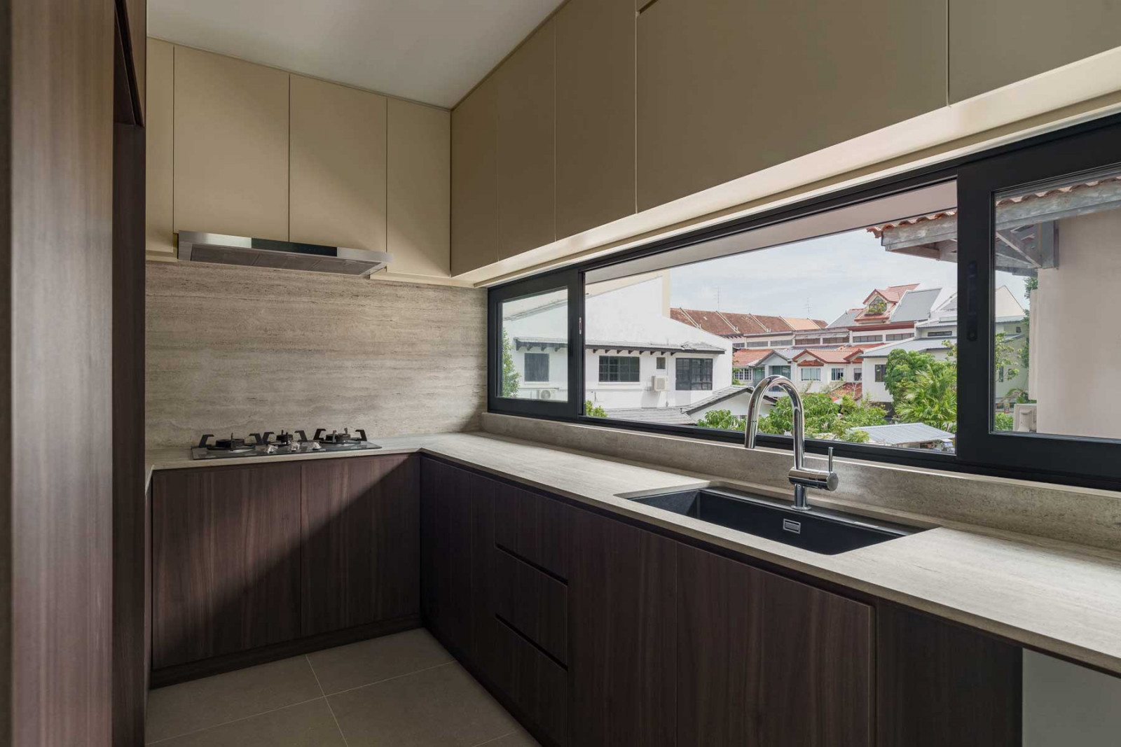 A picture window in the kitchen framing the view of the neighbourhood