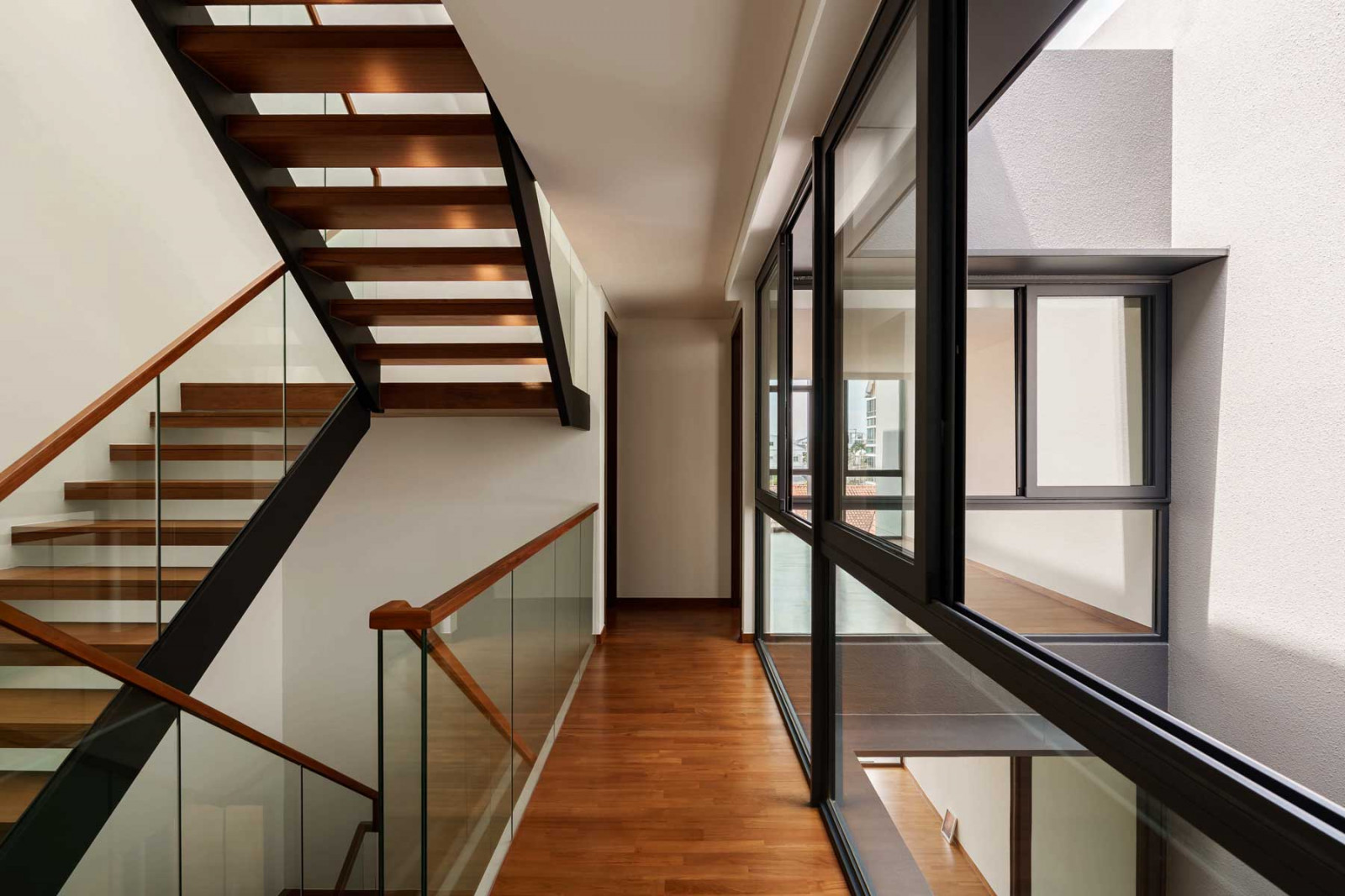 The second-floor corridor, widened with glazed surfaces for a greater sense of openness